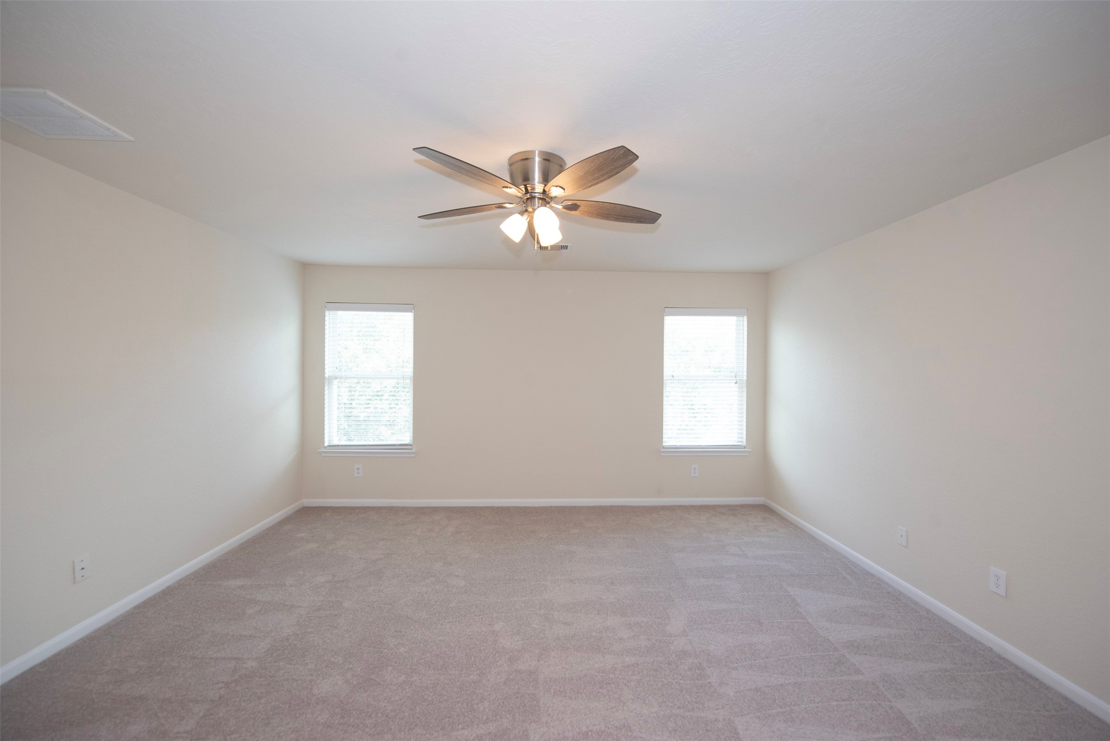 Master Bedroom is huge with ceiling fan located at the back of the home overlooking the backyard.
