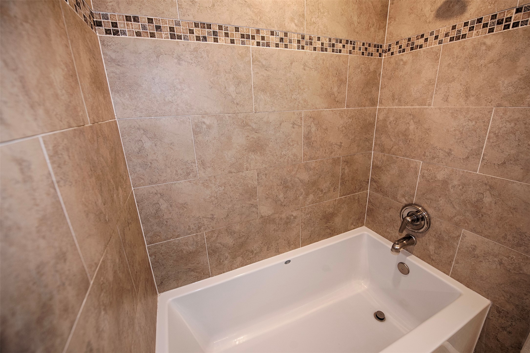 Master bathroom provides a deep soaker tub and gorgeous tile work. Tub big enough to relax and unwind after a long stressful day.