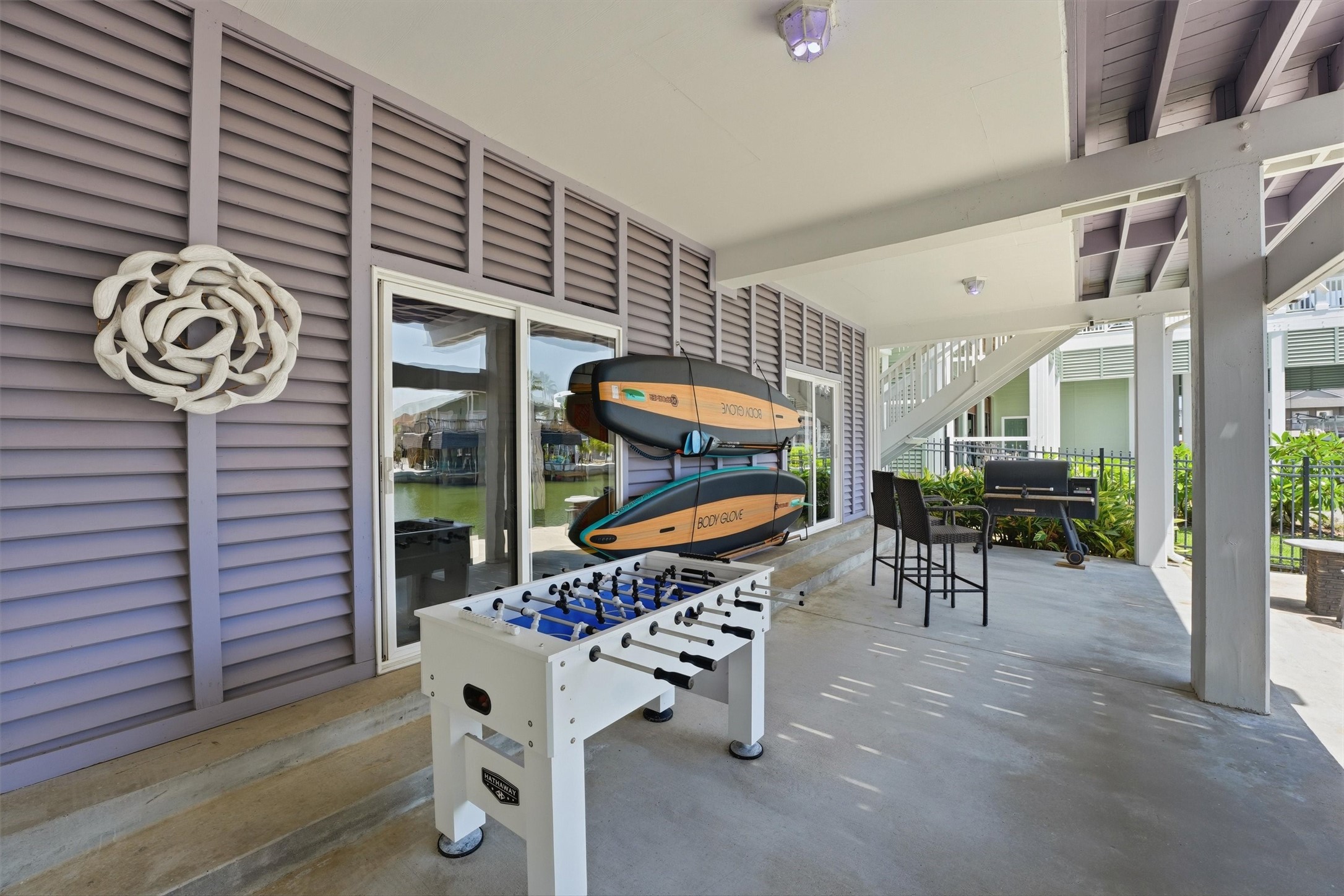 Expansive covered space beneath the home offers plenty of room for games, grilling, and casual gatherings by the water.