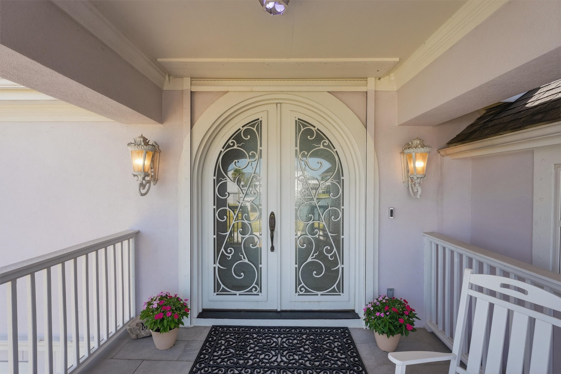The covered front porch offers a welcoming entrance with architectural detailing and decorative double doors. The covered front porch offers a welcoming entrance with architectural detailing and decorative double doors.