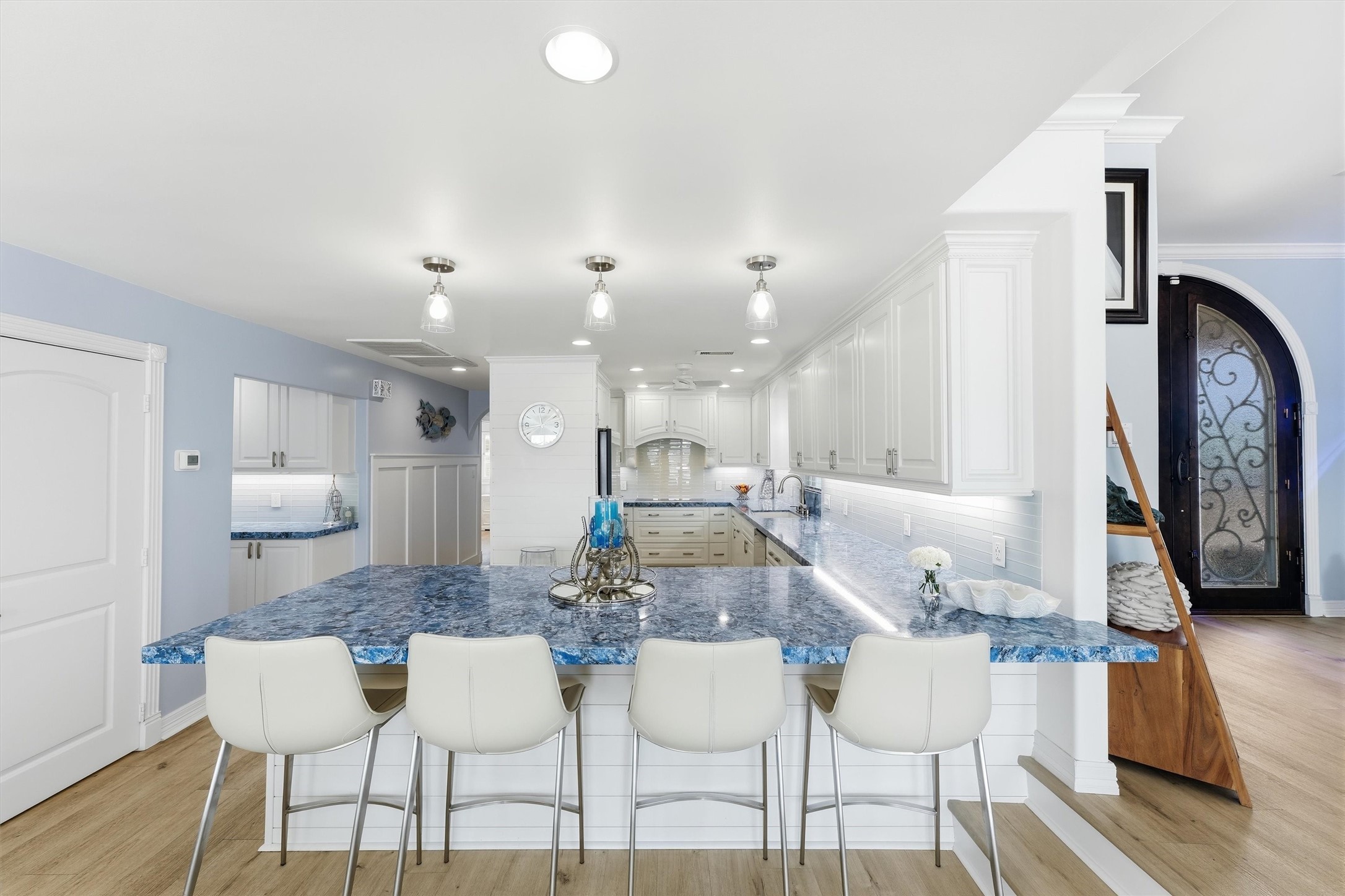 Expansive kitchen features generous counter space, abundant cabinetry, an oversized breakfast bar with seating, and an open layout designed for entertaining. Expansive kitchen features generous counter space, abundant cabinetry, an oversized breakfast bar with seating, and an open layout designed for entertaining.