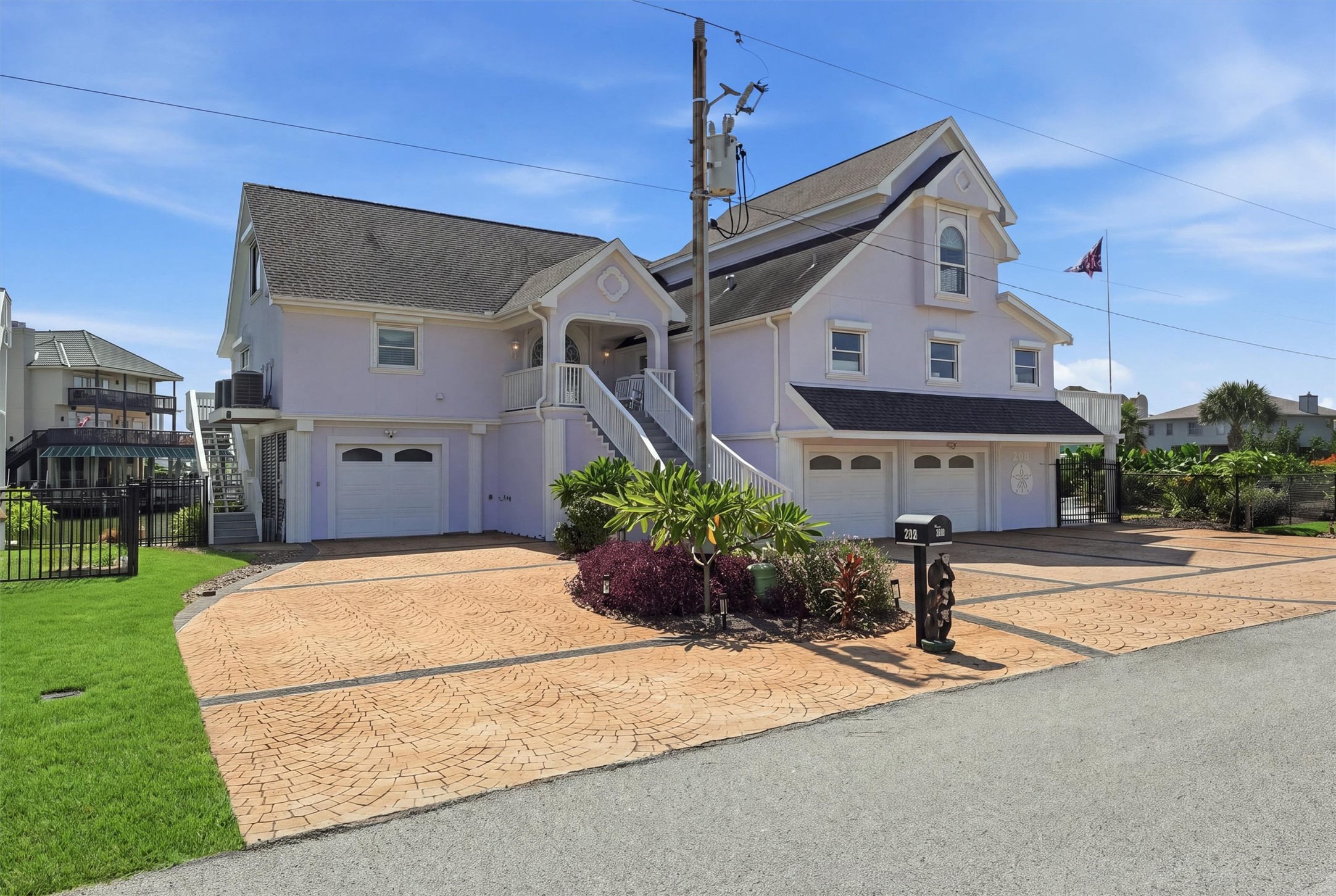 Wide exterior view highlights the generous 15,050 sq ft double lot, five-car garage, and plenty of additional outdoor parking space. Wide exterior view highlights the generous 15,050 sq ft double lot, five-car garage, and plenty of additional outdoor parking space.