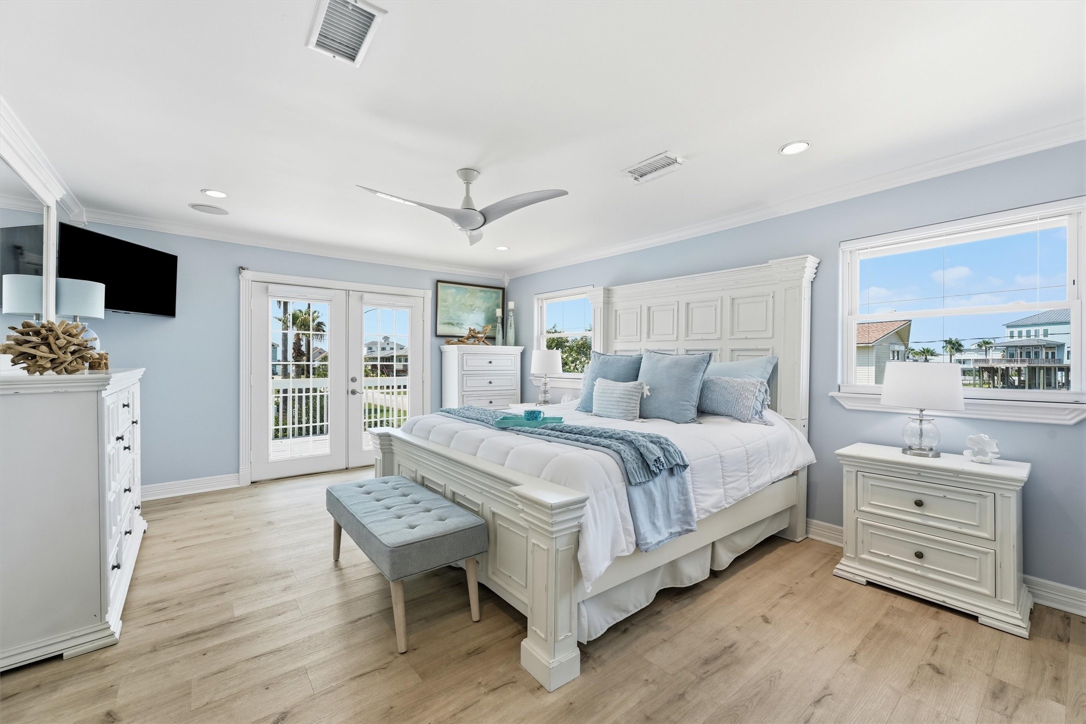 Spacious primary retreat filled with natural light and offering direct access to a private outdoor deck.