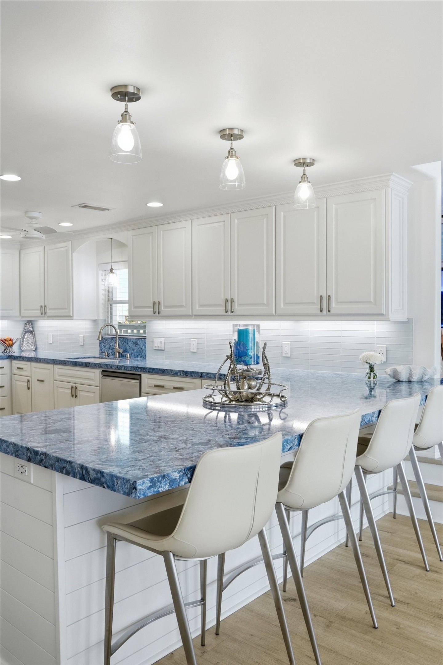 Attention to detail shines in the kitchen, where striking blue quartz countertops create a beautiful statement and bring a custom feel to the oversized island. Attention to detail shines in the kitchen, where striking blue quartz countertops create a beautiful statement and bring a custom feel to the oversized island.