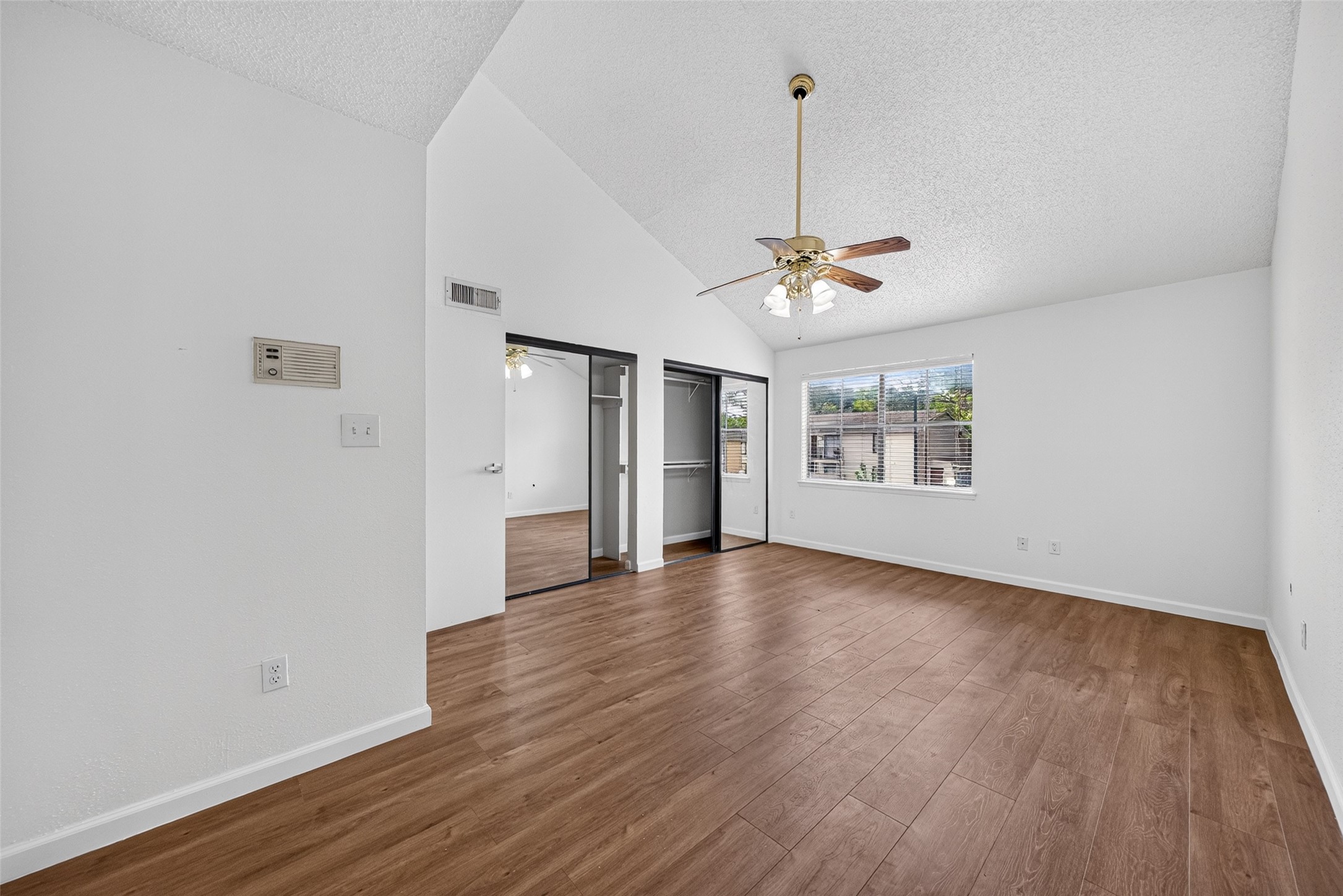 Additional primary bedroom view with closet storage