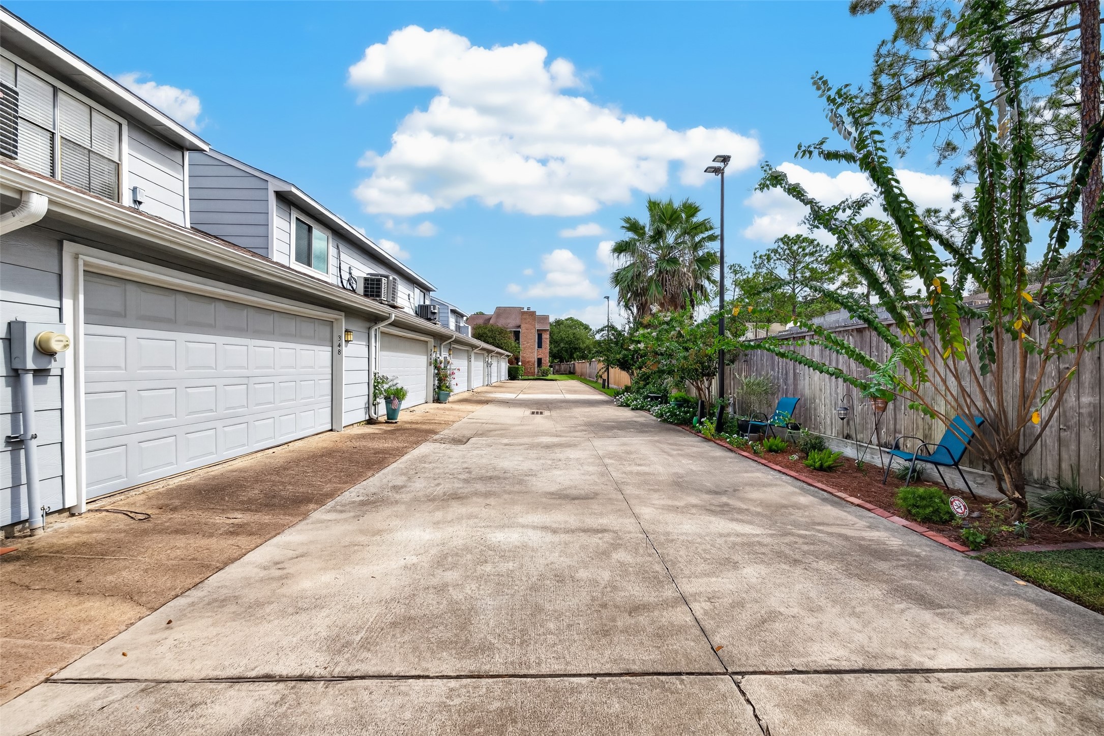 Rear garage access with paved driveway and convenient access to the attached garage.