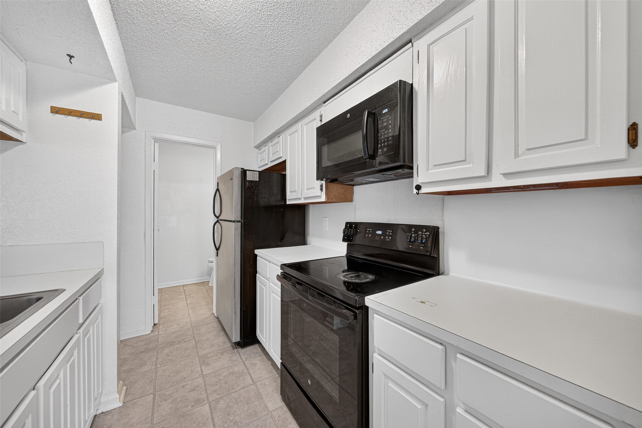 Kitchen featuring black appliances and generous counter space