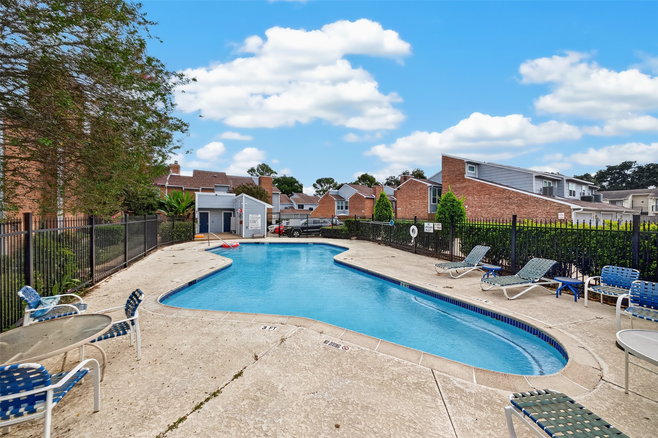 Enjoy the community swimming pool with surrounding lounge chairs and outdoor seating areas.