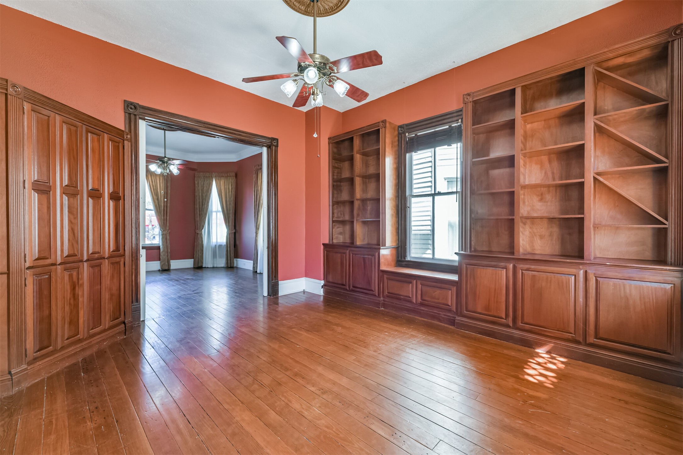 Guests who were well known to the family may have been invited into the more casual and intimate family room that undoubtedly also served as a library, with its walls lined with custom-built shelving and cabinetry with trim that coordinates with the door casings.