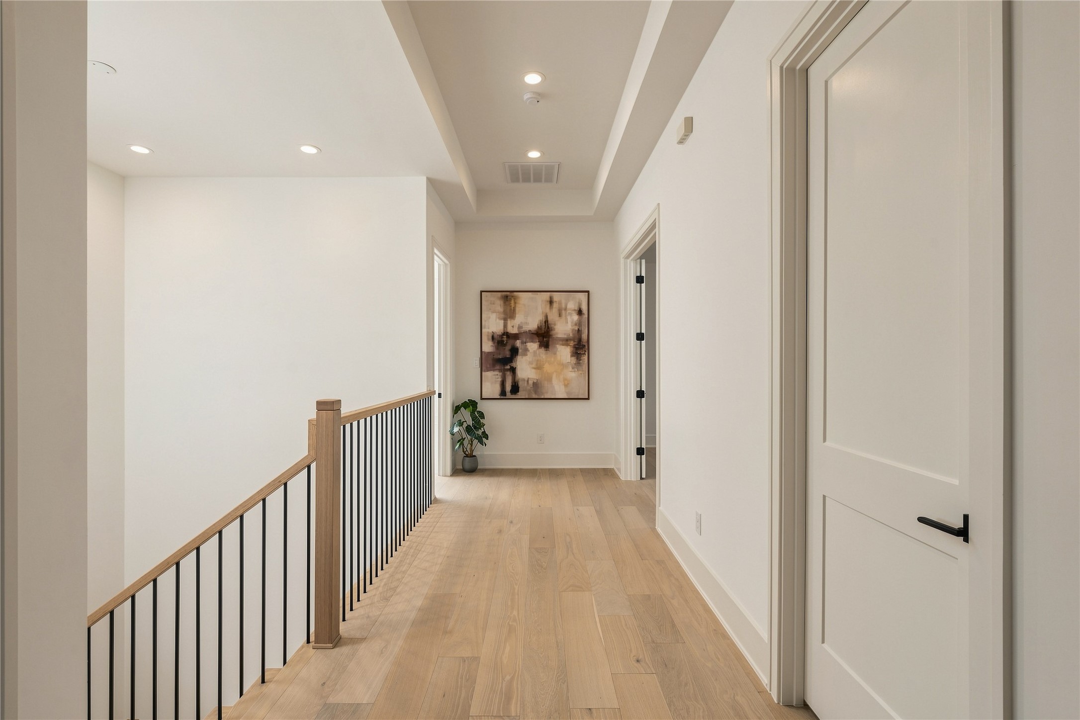 The second-floor landing continues the homes clean architectural language, with 10-foot ceilings and an open stairwell creating an airy transition to the upper-level living spaces.