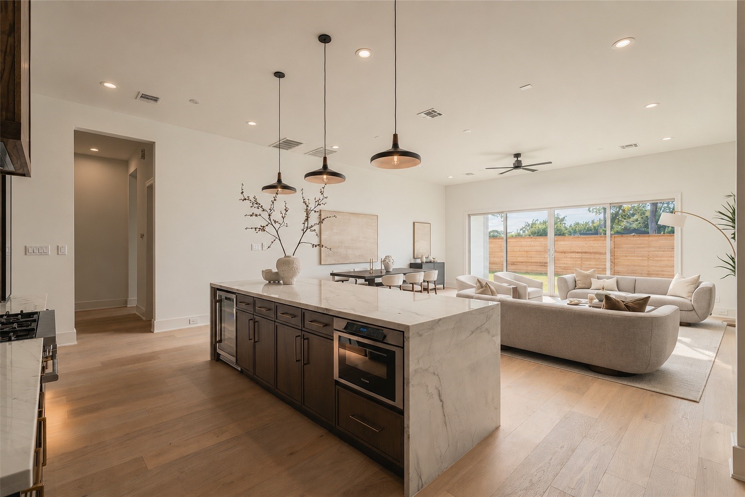 Designed for connection, the kitchen opens effortlessly into the main living area, with the expansive island creating a natural gathering place at the heart of the home.