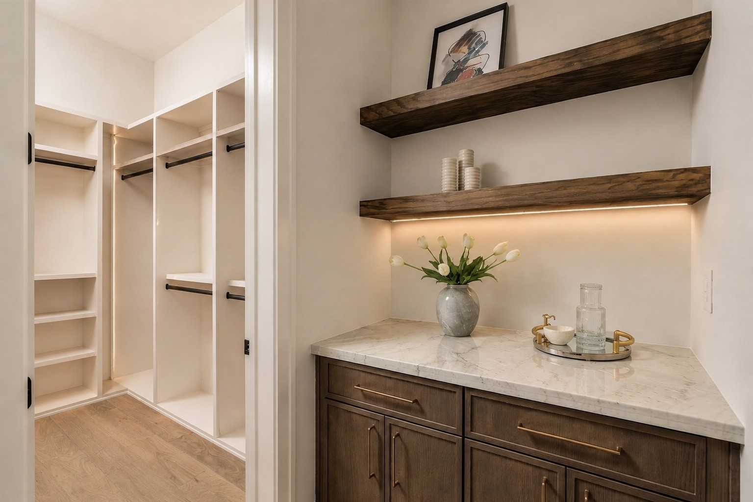 One of two closets in the primary bedroom with dedicated coffee bar within the primary suite adds a hotel-inspired touch, complete with custom cabinetry and open shelving for a refined morning ritual.