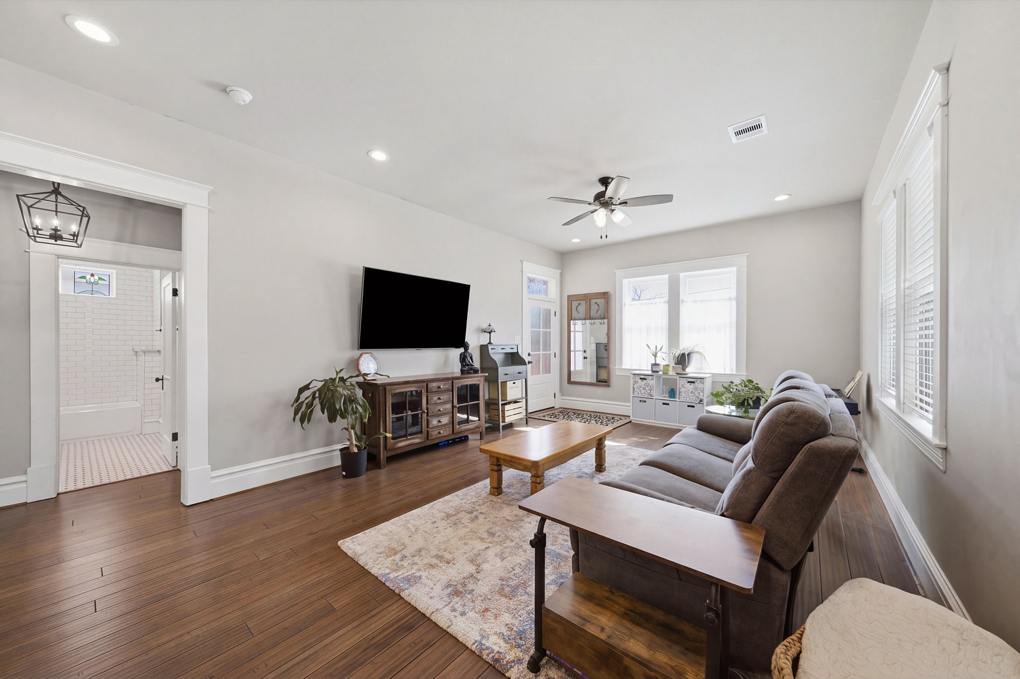 Note the (Jeldwen) wood windows that let in SO MUCH NATURAL LIGHT! Opening on the left leads to 2 guest bedrooms and guest bath. Recessed lighting throughout the Living-Dining-Kitchen!