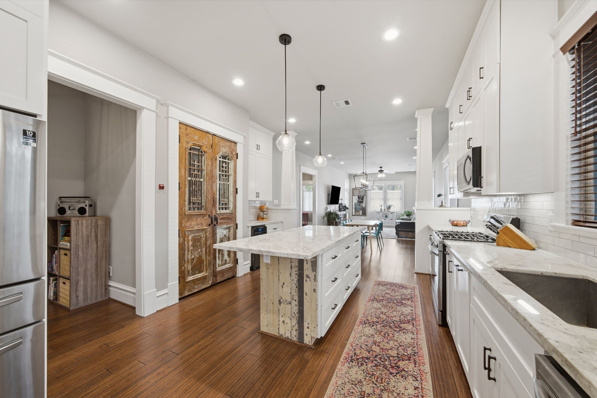 Antique double doors - now used as the pantry doors - SO MUCH STORAGE! 4-door s/s fridge. Note the vestibule on the left - leads to primary bedroom suite!