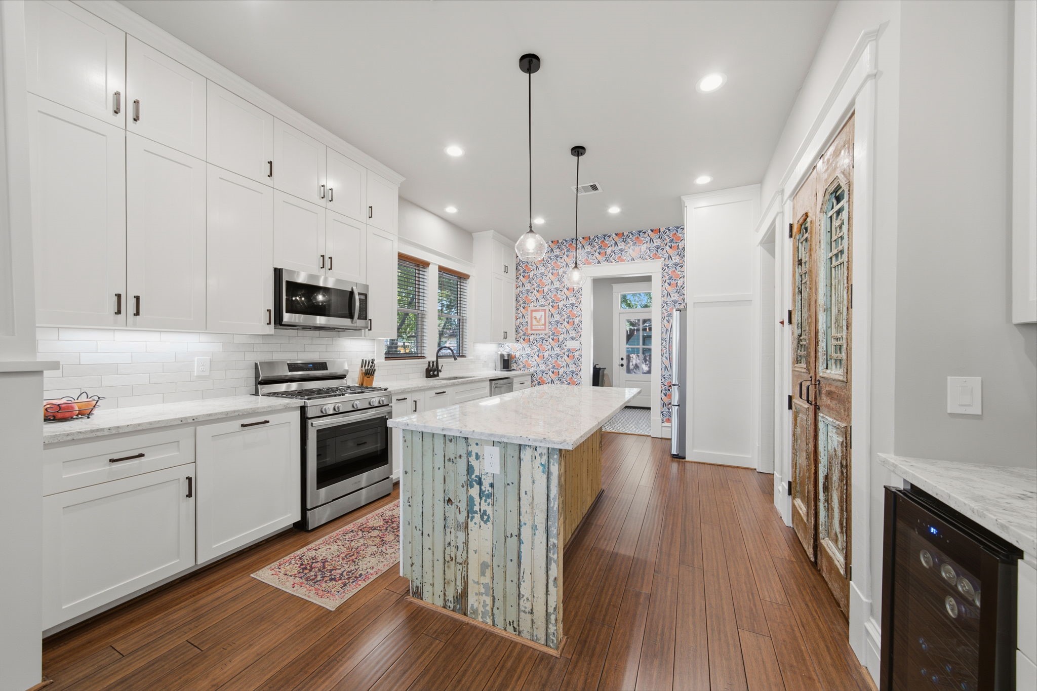 Reclaimed bead board wraps the island - love the historic wood accent! BIG ISLAND for plenty of workspace and seating for 4 people! Plenty of natural light coming through the DOUBLE WINDOWS by kitchen sink!