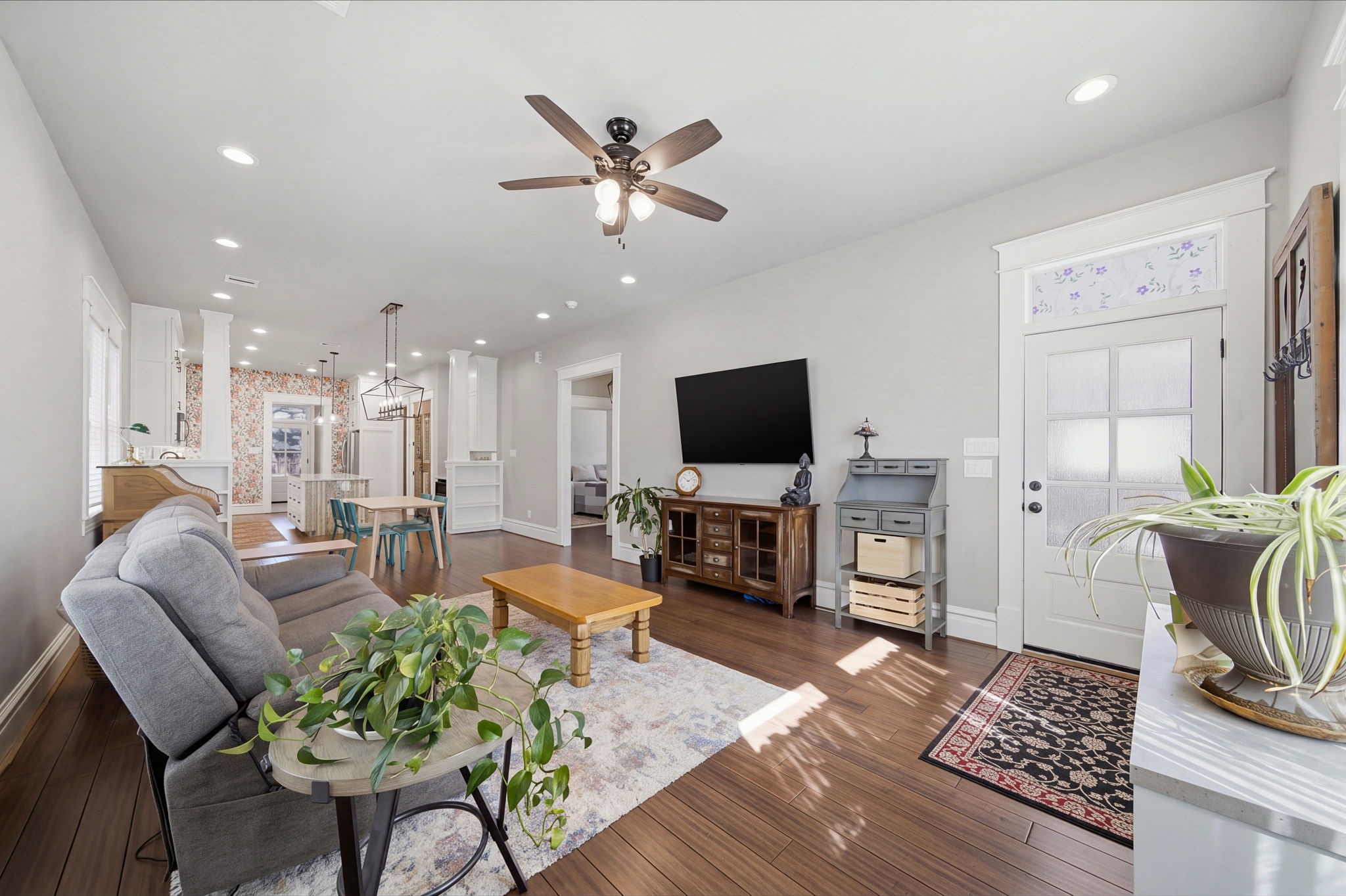 Walk through the front door into the LIVING ROOM. Transom window above the front door! SOLID BAMBOO floors and TALL 10' ceilings throughout the home! No carpet!