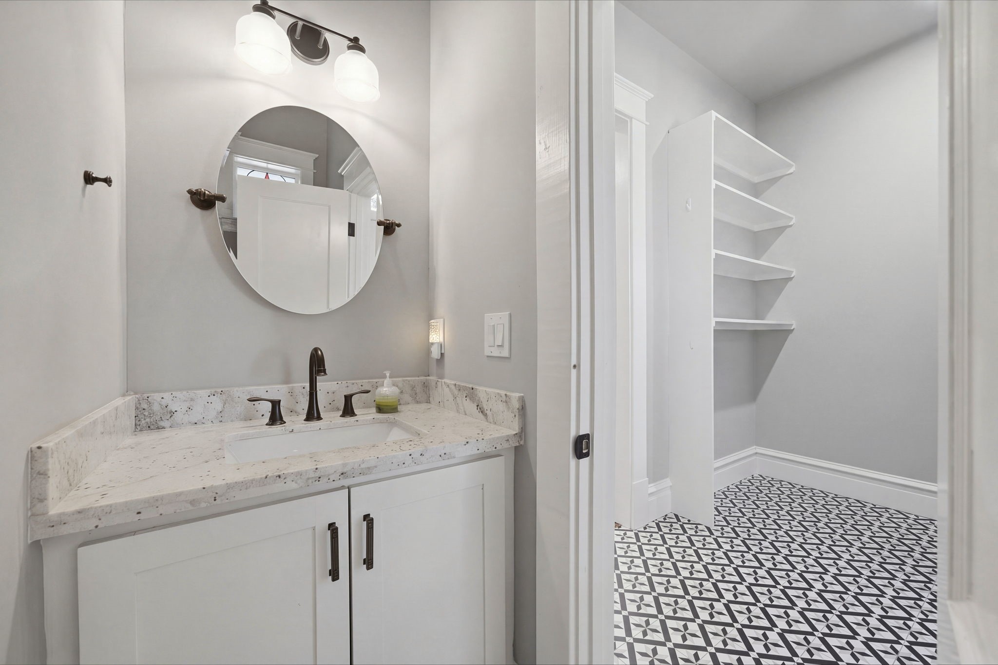 Half bath - close enough for dinner guests, but tucked away for privacy! Note the storage space and shelves in the laundry / mudroom area!