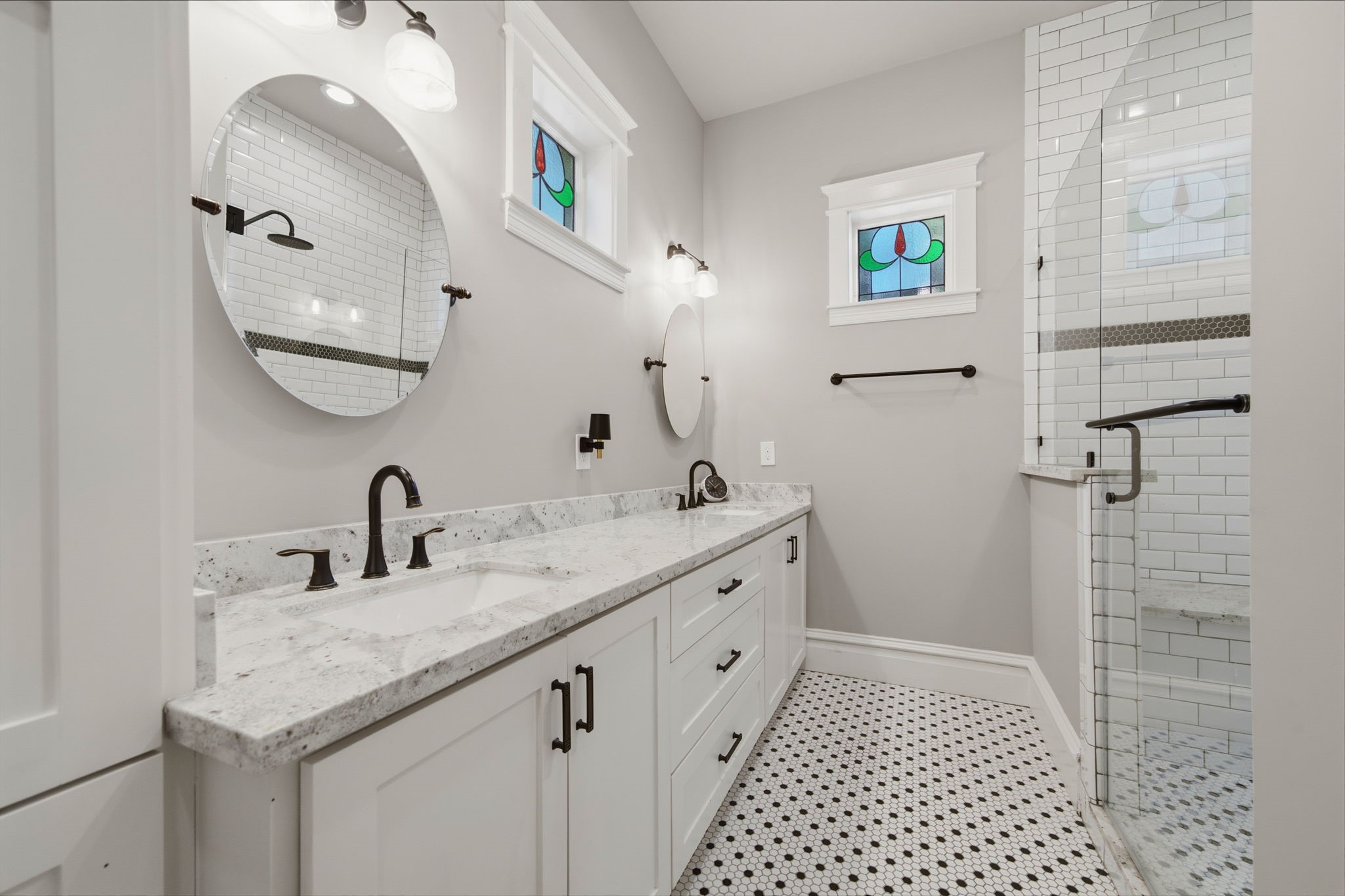 Primary bath - DOUBLE SINKS, GRANITE counters, two stained glass windows! There is also a large linen closet and WC room ini this primary bath!