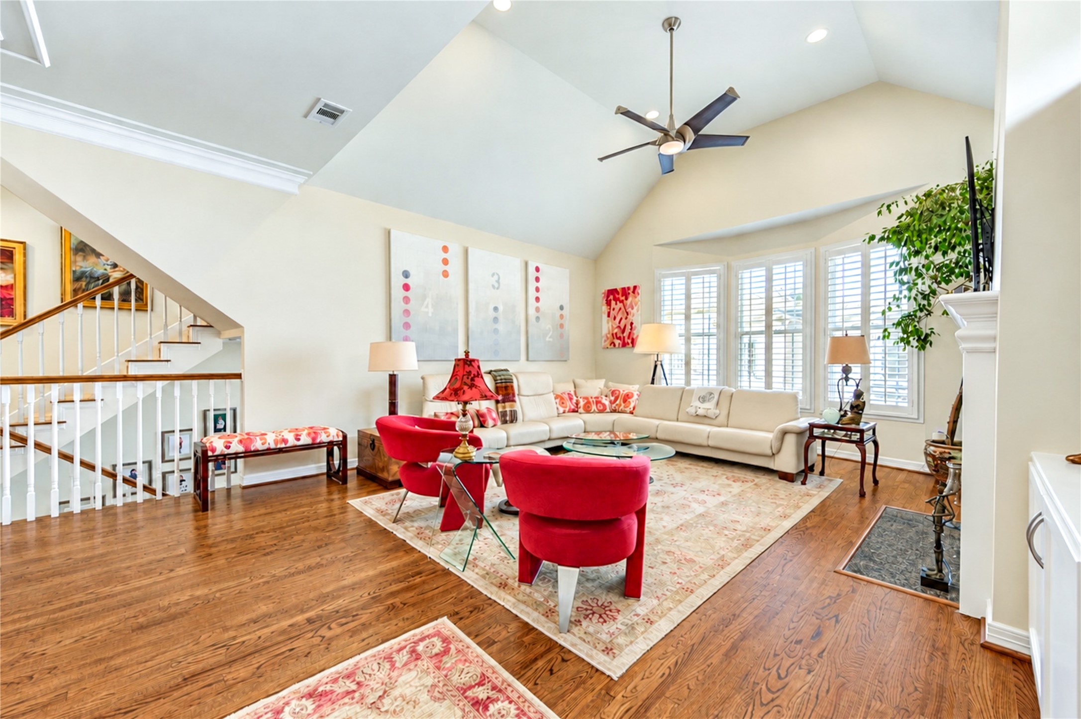 Soaring vaulted ceilings, expansive shuttered windows and rich hardwood floors create a bright, inviting second-floor living room. Soaring vaulted ceilings, expansive shuttered windows and rich hardwood floors create a bright, inviting second-floor living room.