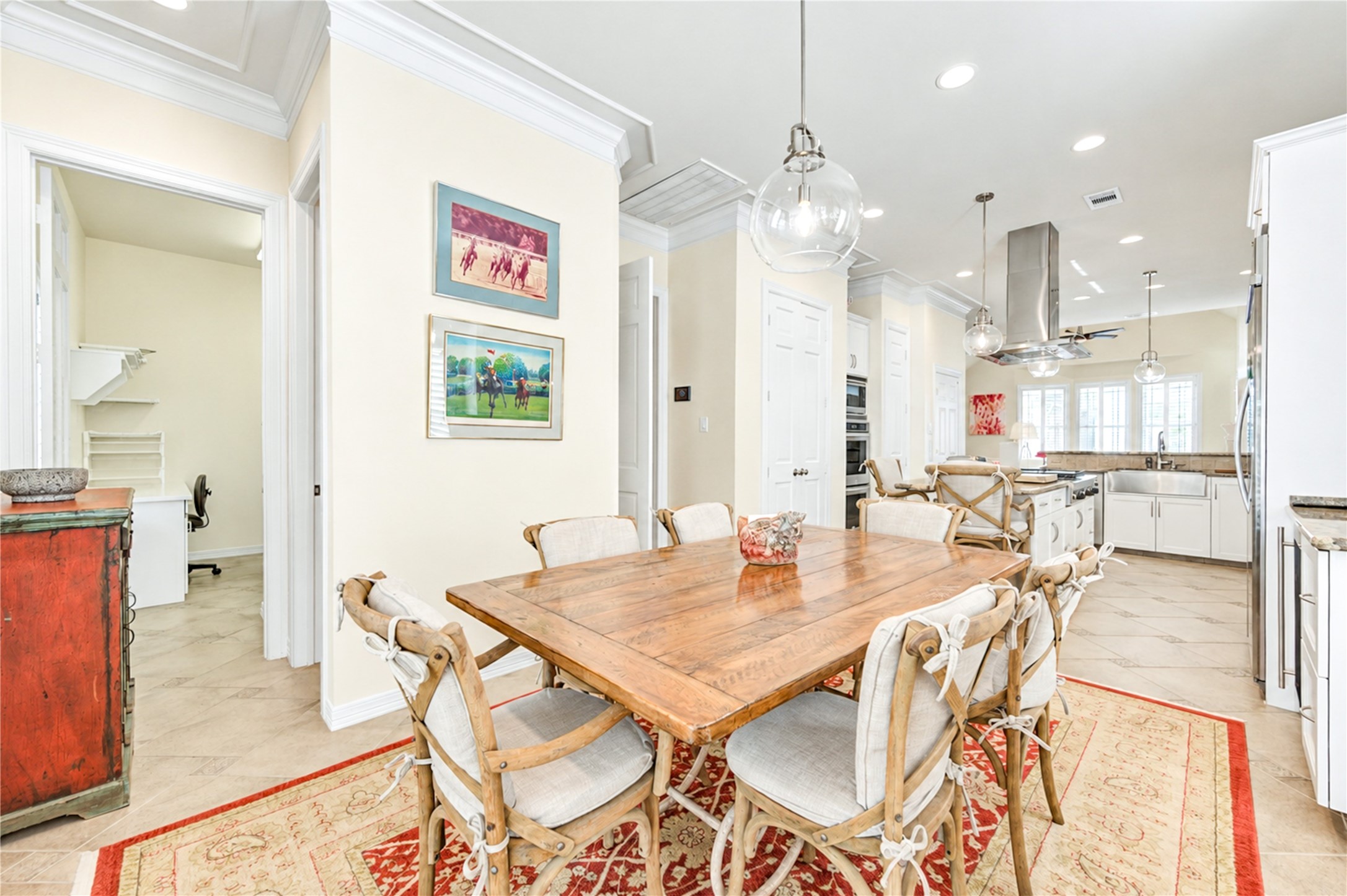 The inviting breakfast area features tile flooring and crown molding, with an open connection to the beautifully appointed island kitchen.