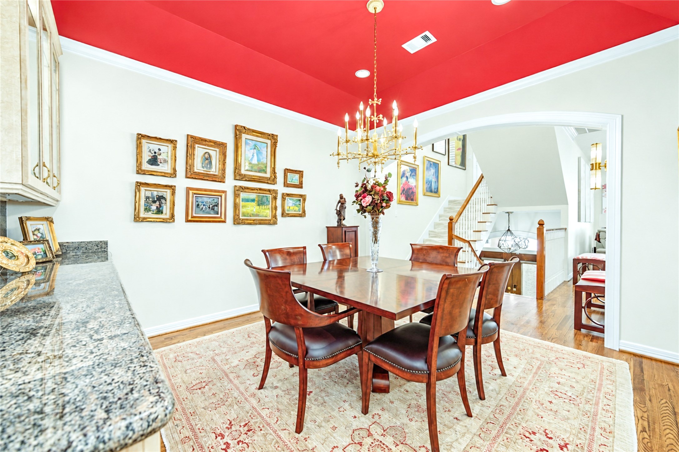 The second-floor formal dining room offers crown molding, hardwood floors and custom built-in cabinetry with a granite-topped buffet.