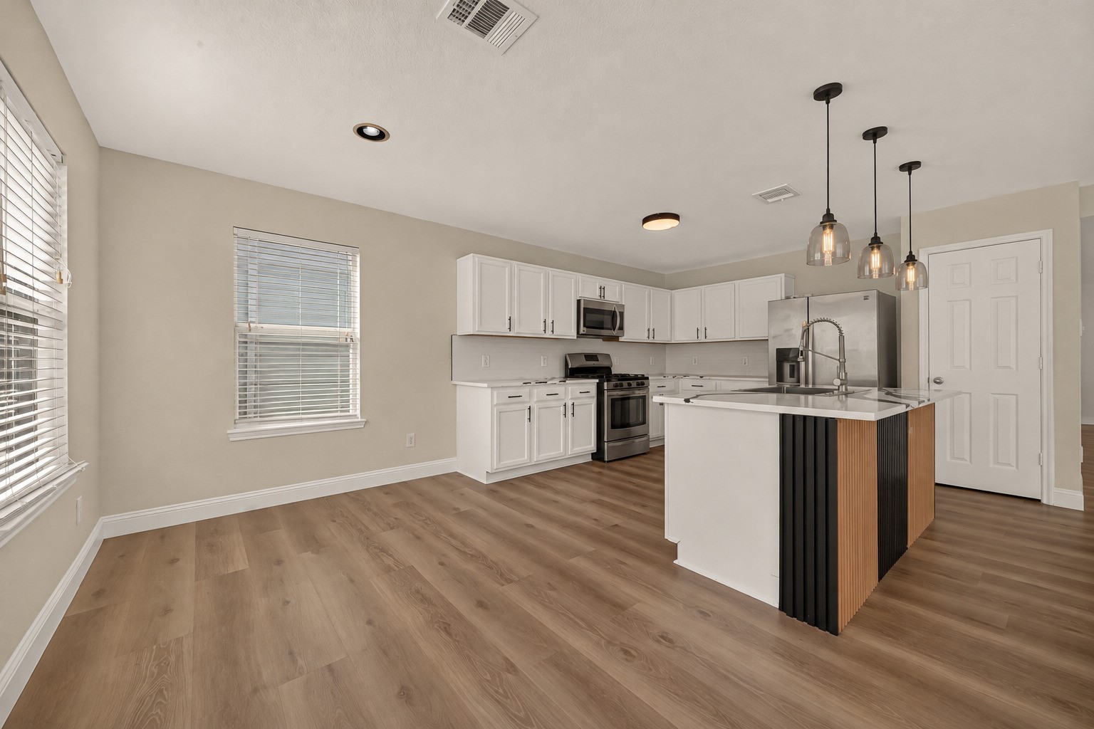 Set beside the kitchen, this bright breakfast corner benefits from natural light streaming through the windows. A nearby glass-paneled door provides direct access to the backyard, adding a convenient connection between indoor dining and outdoor enjoyment.