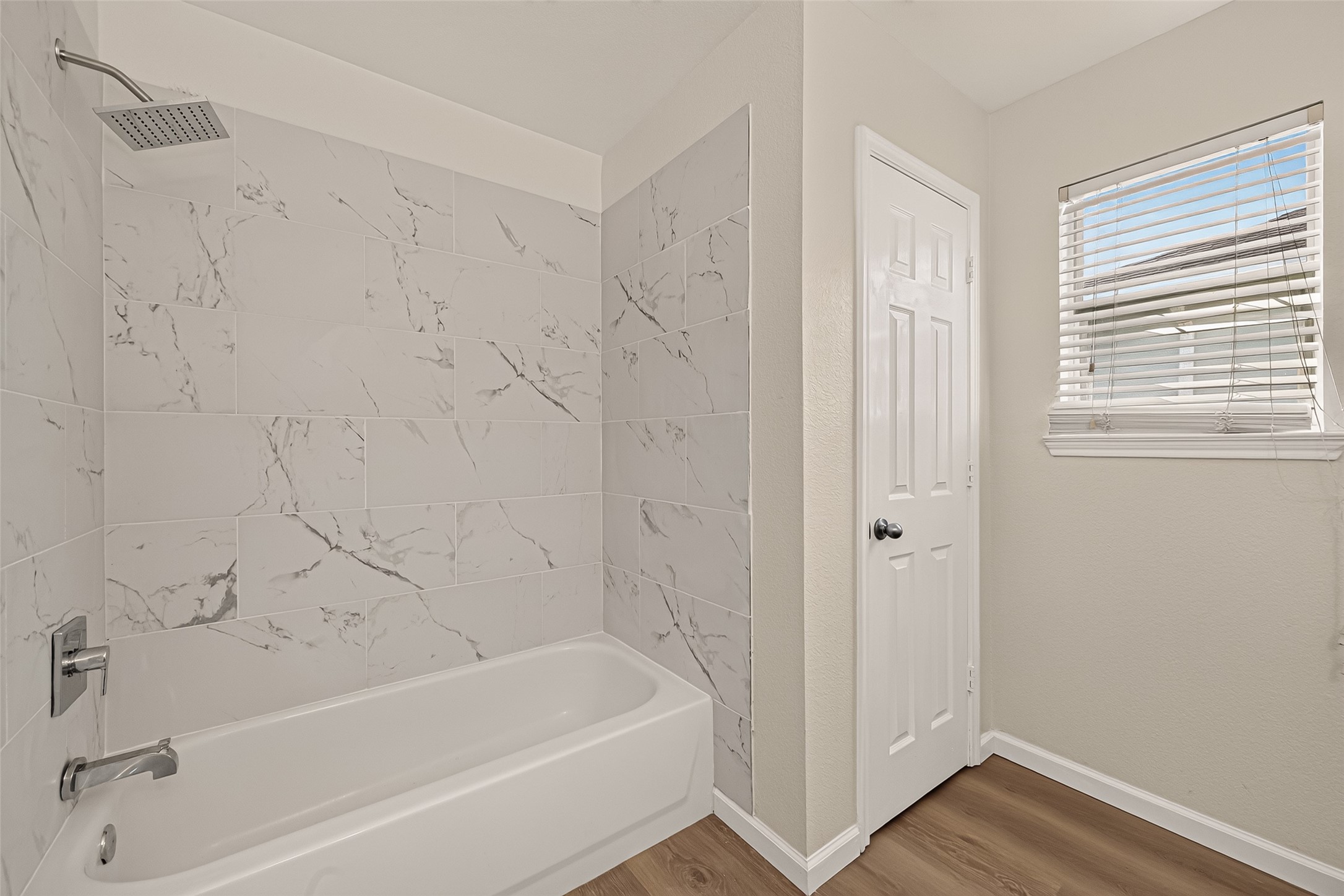 The tub-and-shower combination provides flexibility for both a quick morning routine and a relaxing soak.