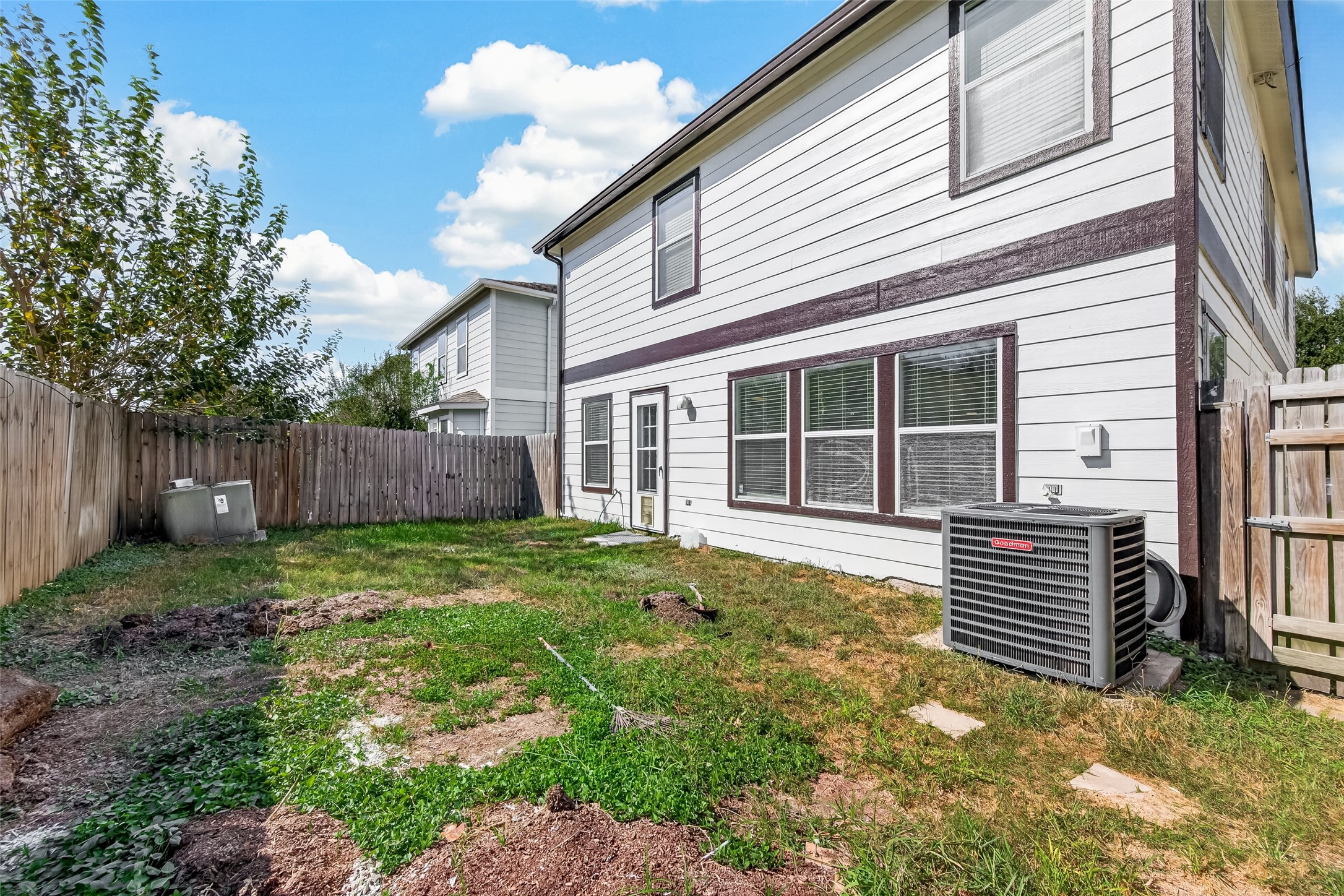 A spacious, fenced backyard offers room to envision outdoor dining, gardening, play, or a comfortable seating area under the open sky. With a defined perimeter and plenty of usable space, the yard presents opportunities to personalize the outdoors to suit your lifestyle.