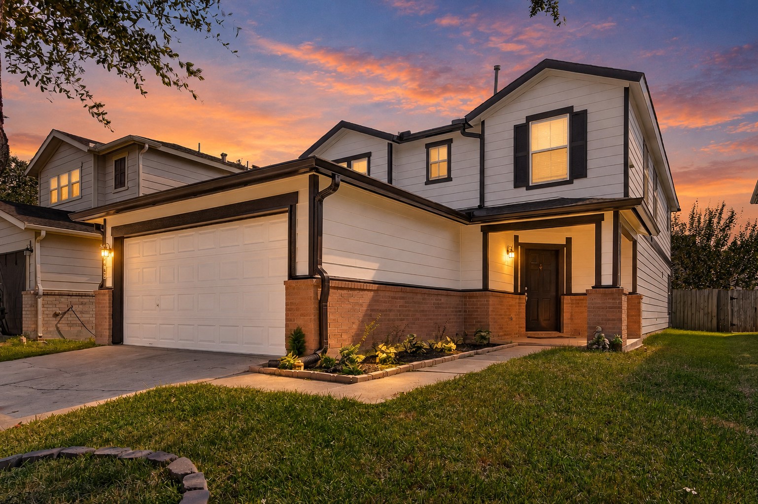 A beautiful front elevation takes on added character at twilight, with the home's exterior details illuminated against the evening sky and the welcoming entry creating an inviting first impression.