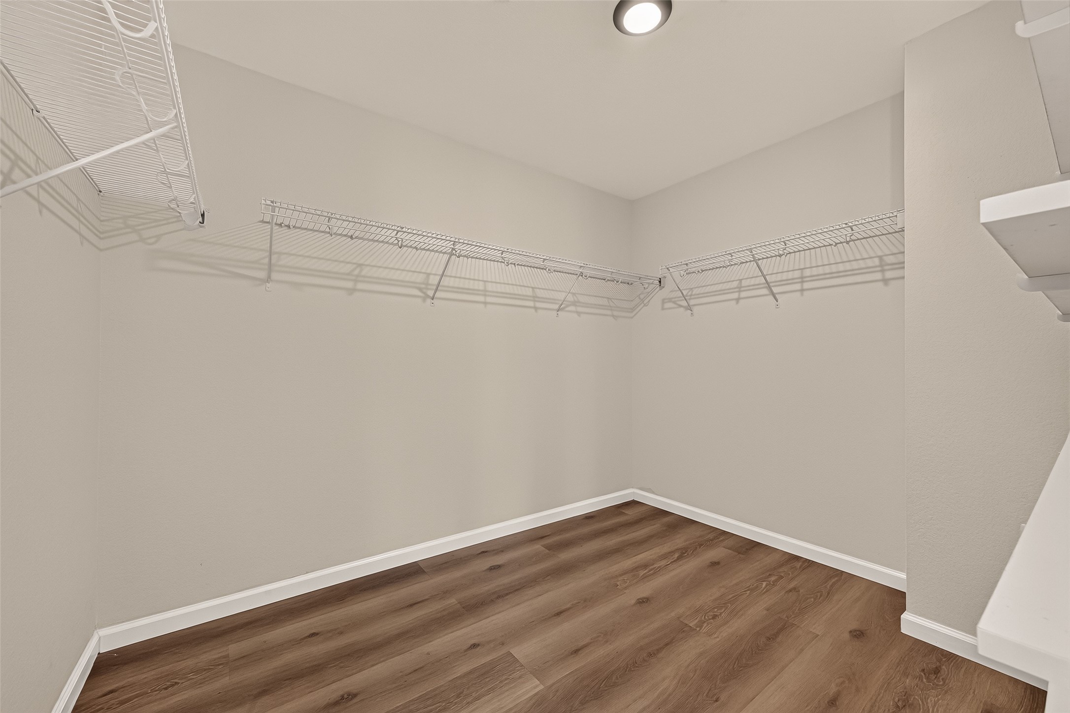 A full-entry closet outfitted with shelving and overhead racks provides dedicated places for clothing, accessories, and seasonal items. The organized storage layout helps make the most of the available space.