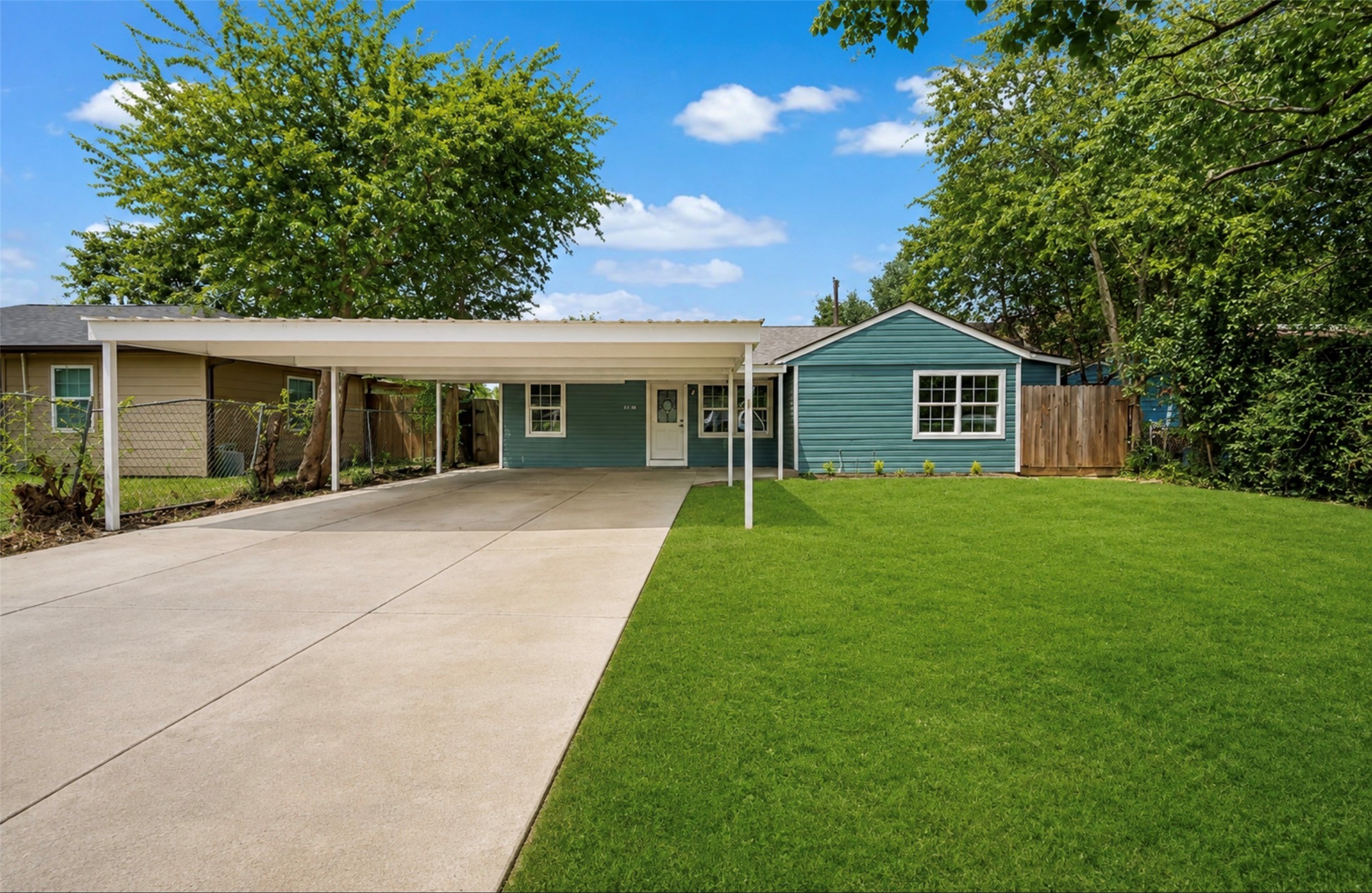 Photoshopped/Enhanced Photo: Front view of this beautifully remodeled home showcasing ample driveway parking and a covered carport, providing convenient shade and protection from the Texas sun while helping keep the front of the home cooler. Photoshopped/Enhanced Photo: Front view of this beautifully remodeled home showcasing ample driveway parking and a covered carport, providing convenient shade and protection from the Texas sun while helping keep the front of the home cooler.