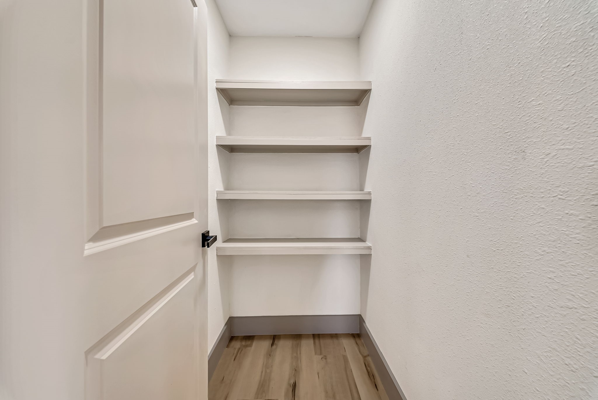 Walk- in pantry with built-in shelving, perfect for organizing essentials.