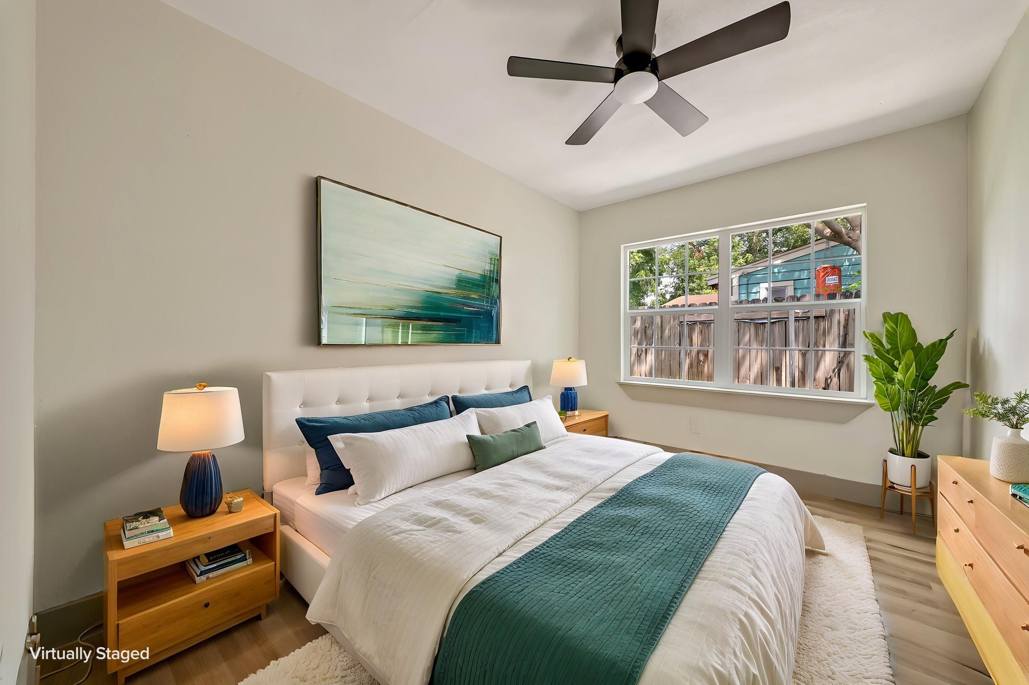 (Photoshopped) Experience restful elegance in this virtually staged bedroom, featuring a serene color palette, abundant natural light, and stylish modern furnishings that create an inviting retreat.