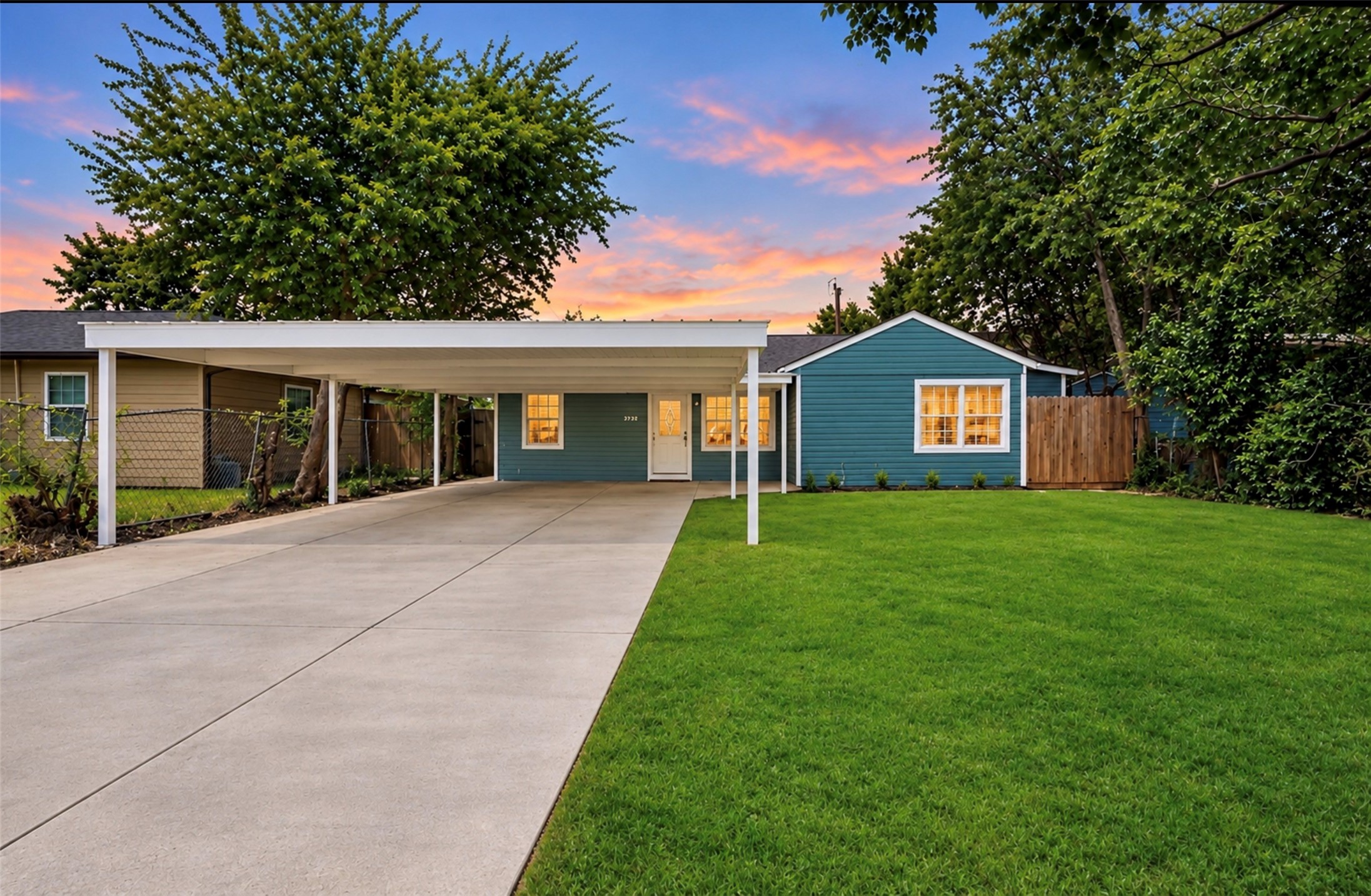 Photoshopped/Enhanced Photo: Front view of this beautifully remodeled home showcasing ample driveway parking and a covered carport, providing convenient shade and protection from the Texas sun while helping keep the front of the home cooler. Photoshopped/Enhanced Photo: Front view of this beautifully remodeled home showcasing ample driveway parking and a covered carport, providing convenient shade and protection from the Texas sun while helping keep the front of the home cooler.
