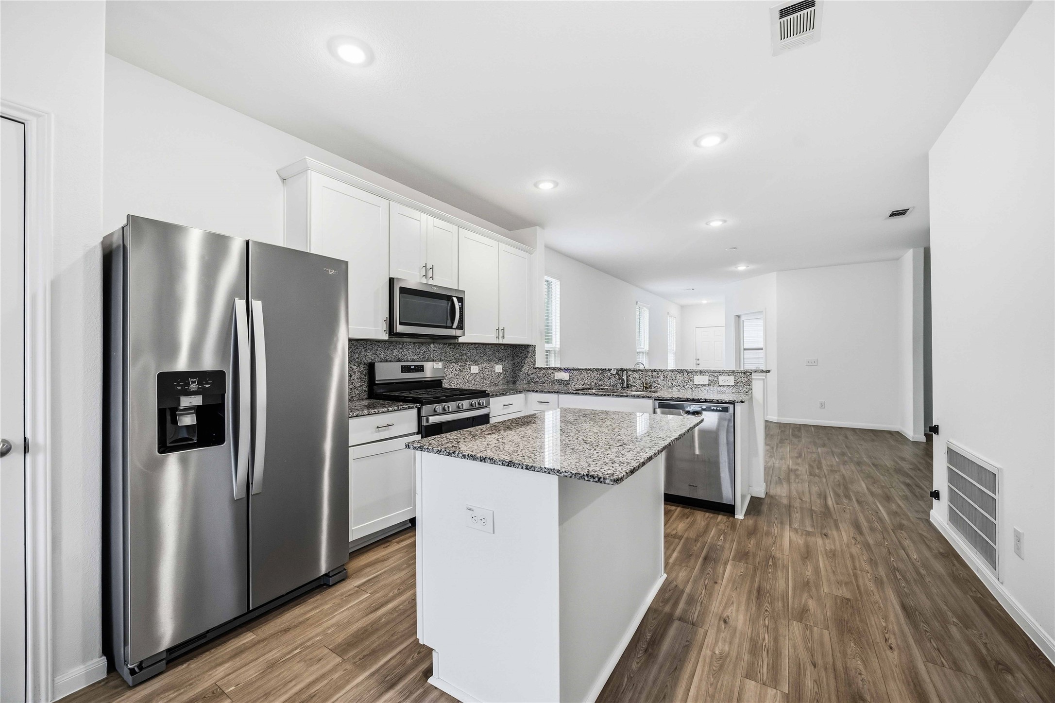 Kitchen island provides additional prep space and storage.