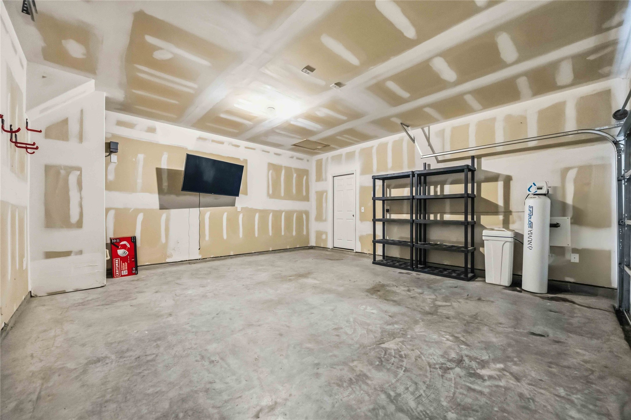 Attached two-car garage with concrete flooring.