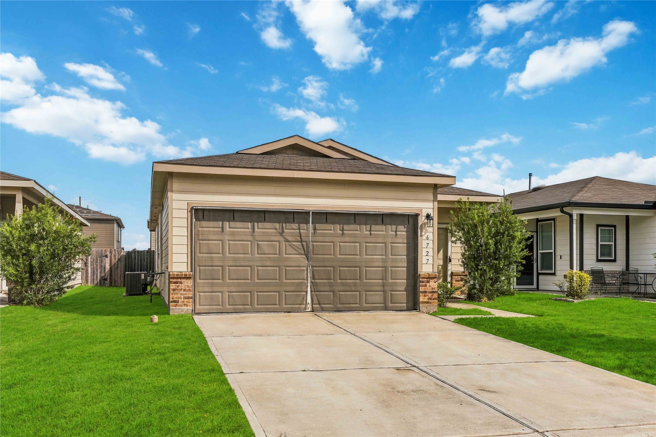 Wide driveway with a walkway leading to the front entrance.