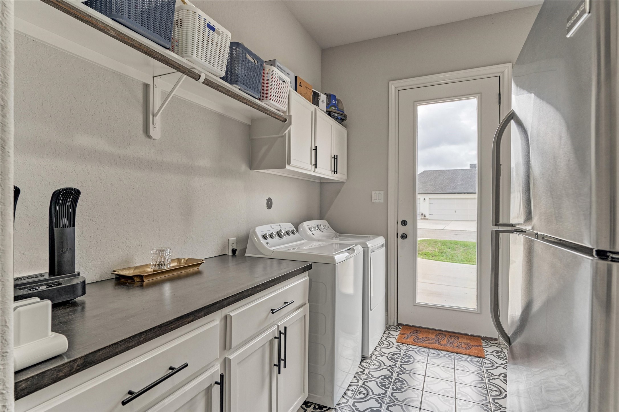 Utility room with lots of storage space and room for an extra refrigerator