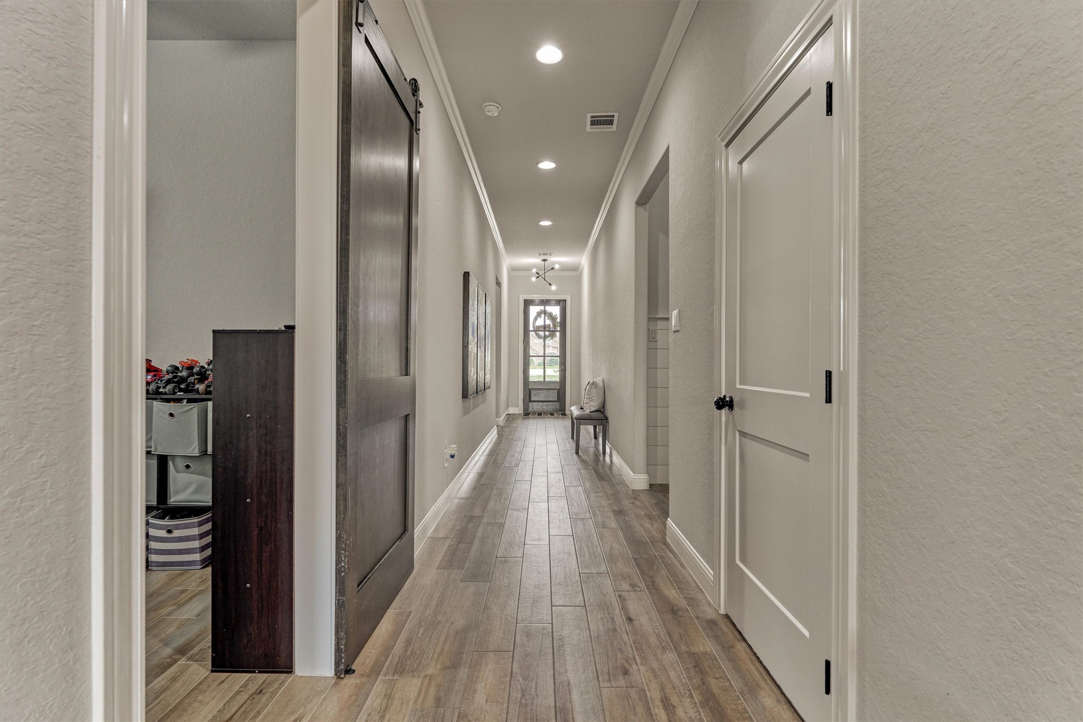 Crown molding, beautiful flooring, and custom lighting.