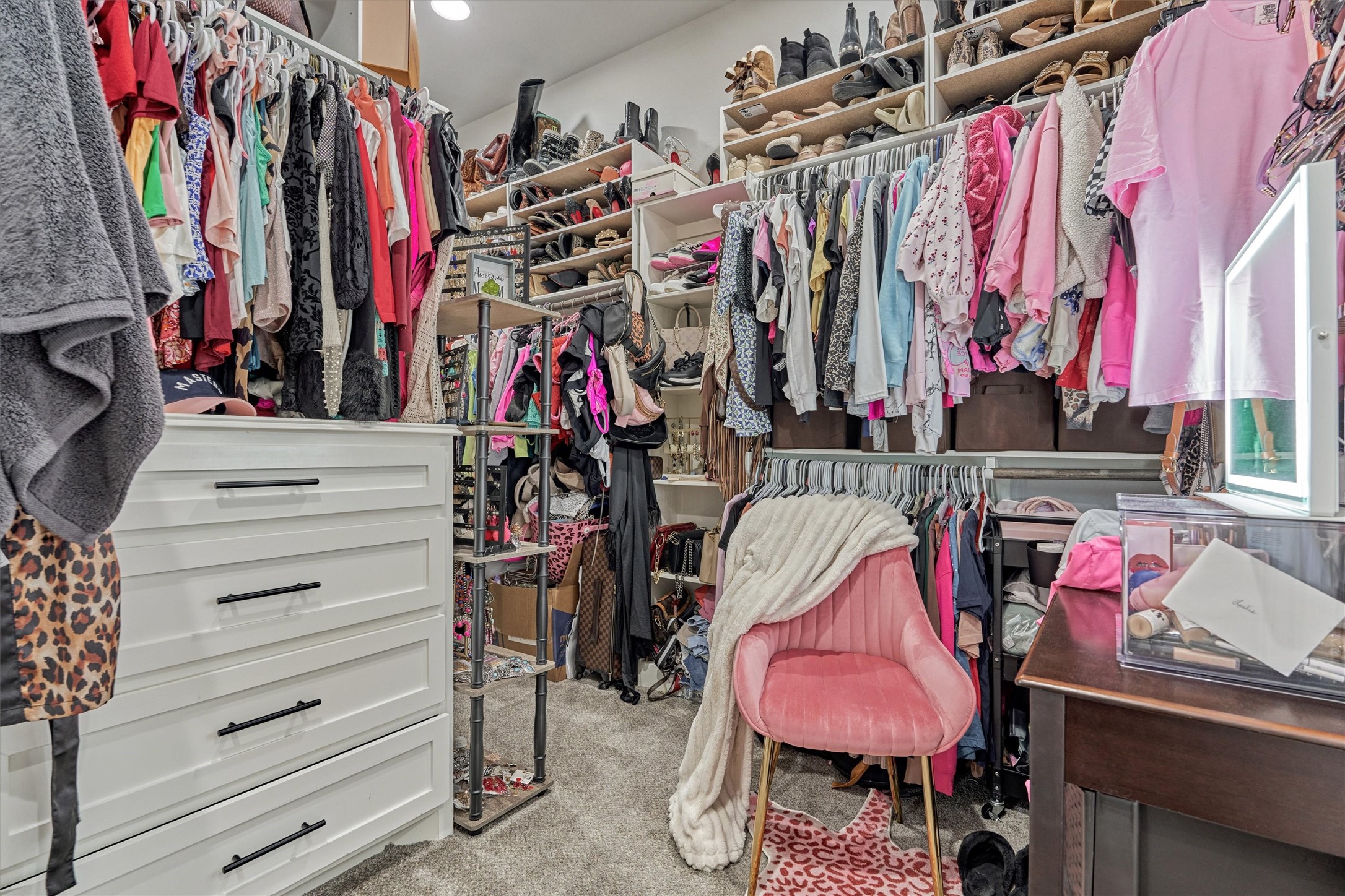 Large primary closet with built in cabinetry