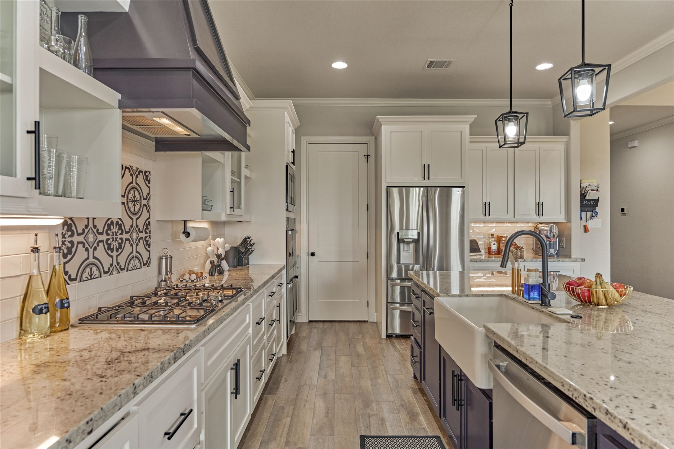 Featuring a deep kitchen sink, and a gas stove top.
