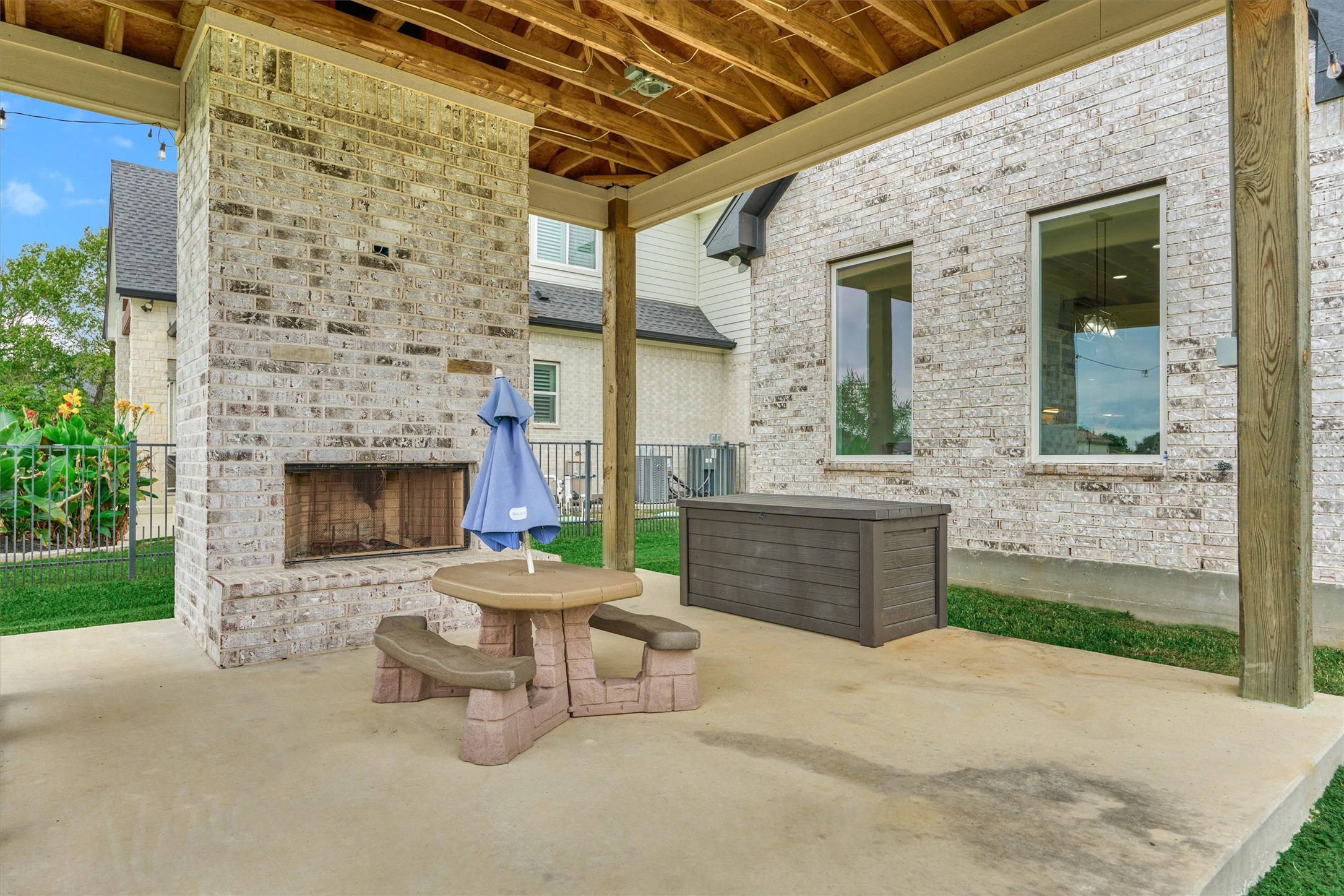 The backyard has a covered patio, complete with a fireplace and a place to put your grille!