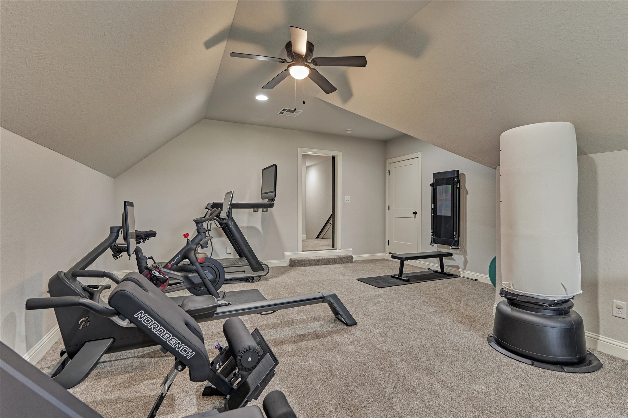 The upstairs flex space features direct access to a floored in attic, perfect for extra storage.