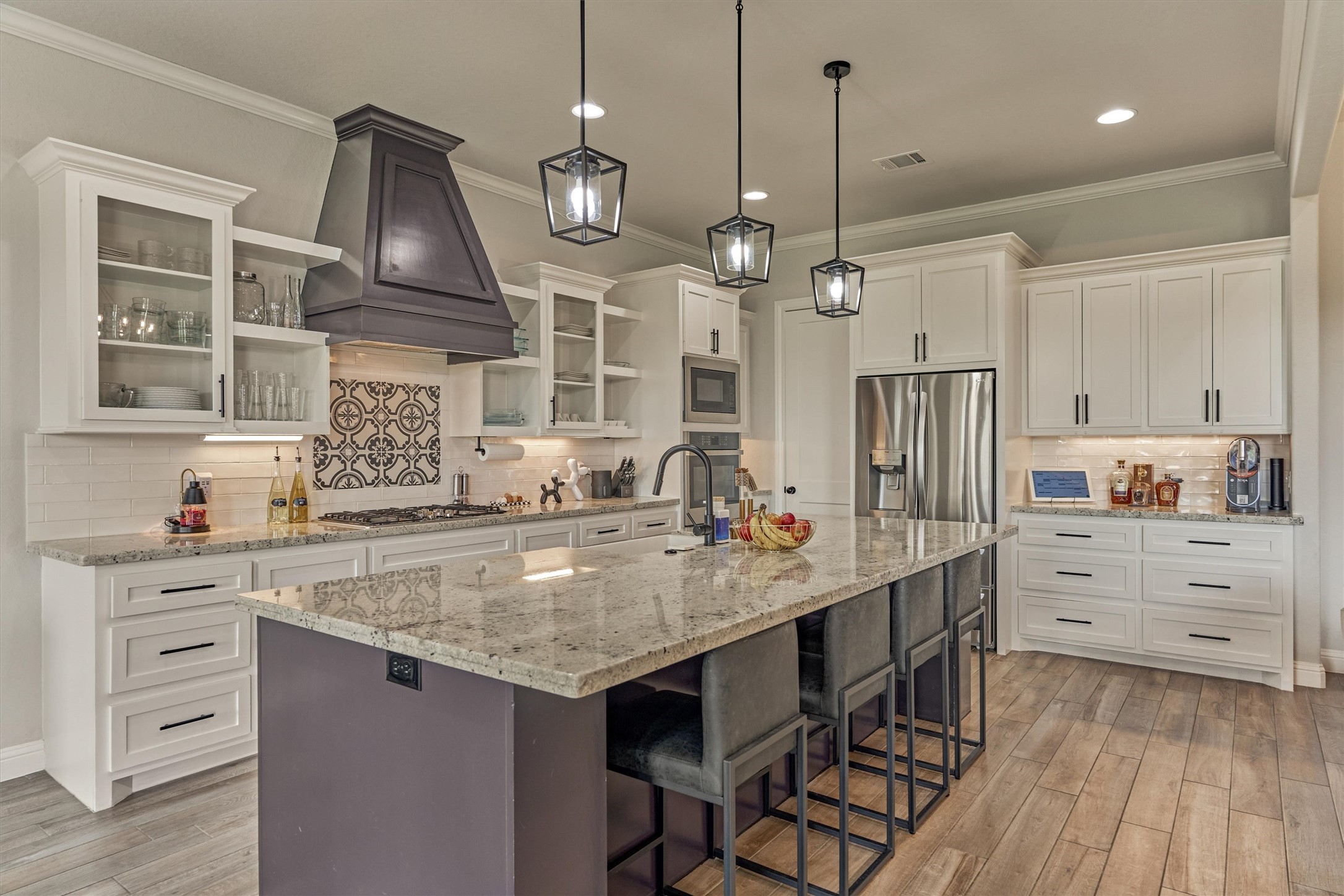 Granite countertops and custom backsplash complete this kitchen.