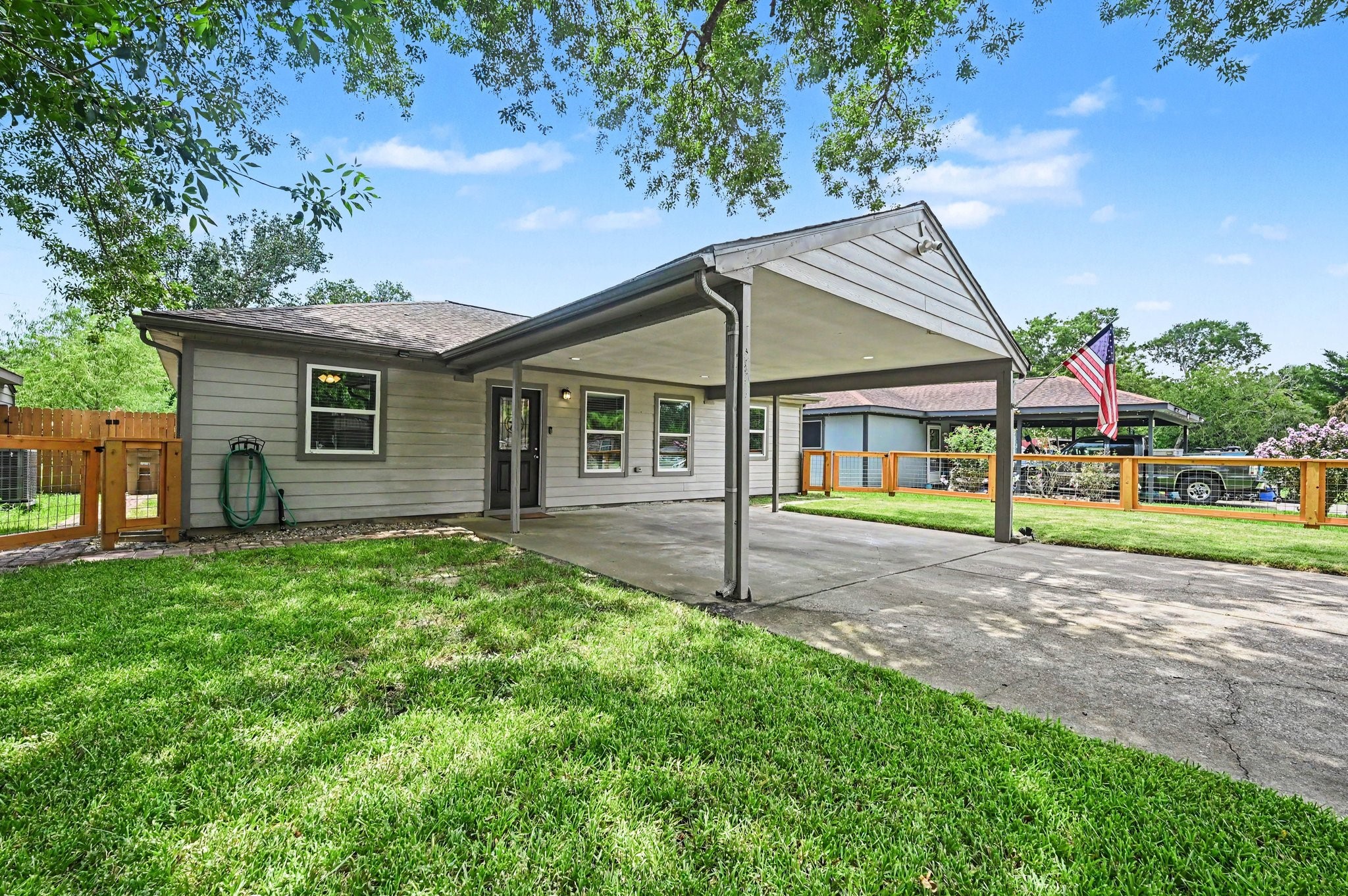 The home offers covered parking that fits 2 vehicles with ease. The front yard is almost fully fenced in. A gate can be added if you desire.