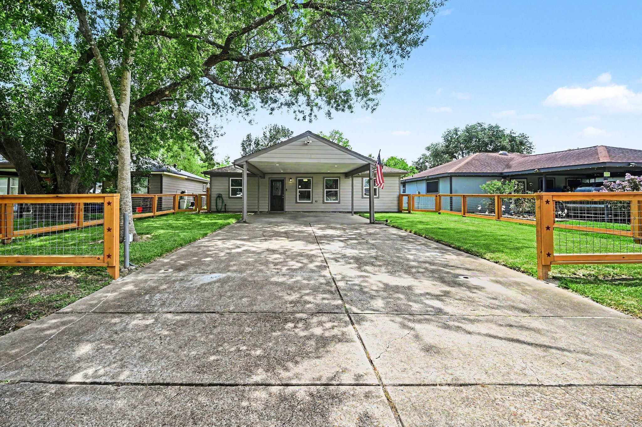 The home offers covered parking that fits 2 vehicles with ease. The front yard is almost fully fenced in. A gate can be added if you desire.