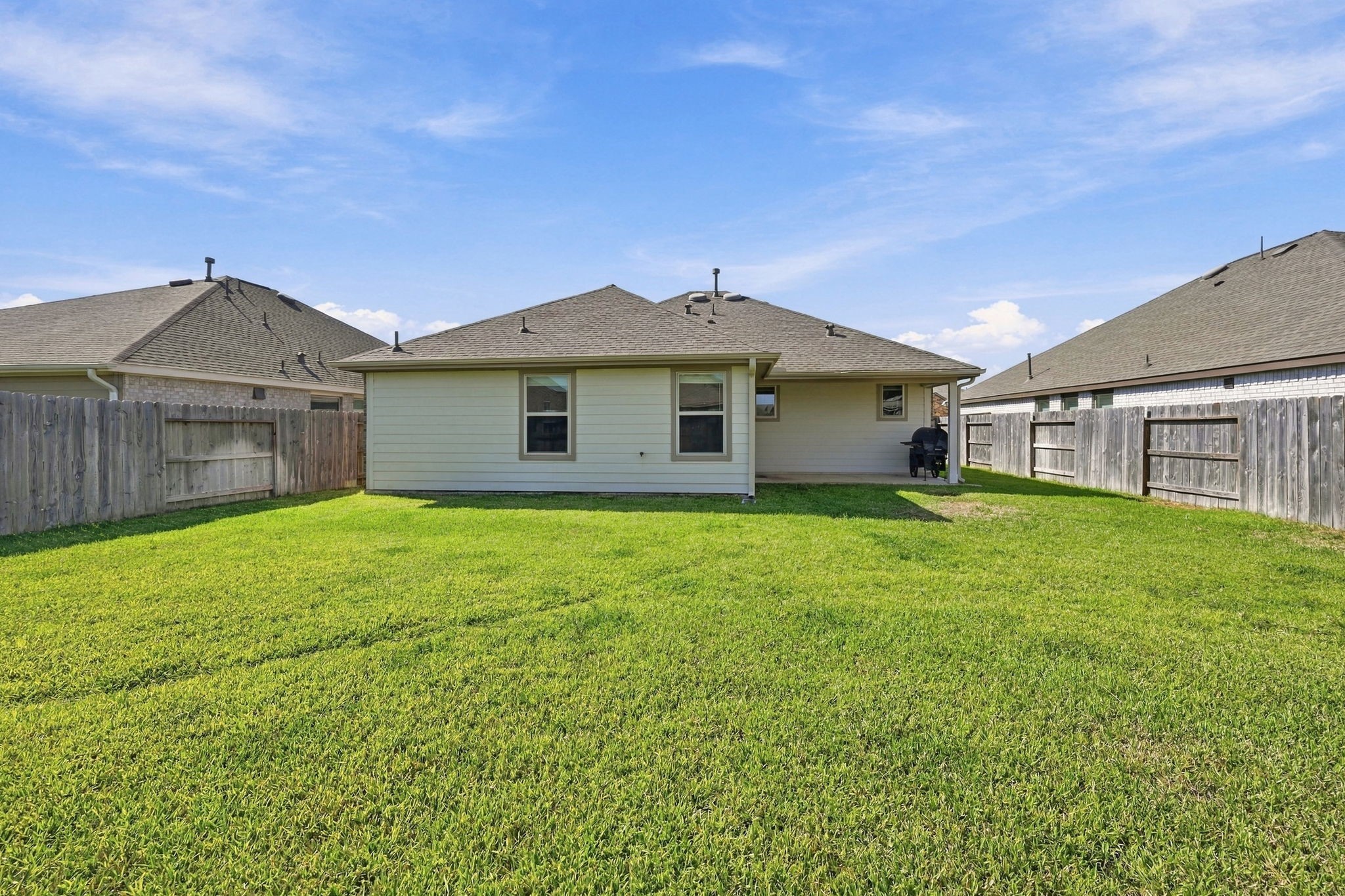 This expansive backyard offers an abundance of green space, ready for a garden, shade trees, or even a future pool. Its a blank canvas just waiting for your personal touch!