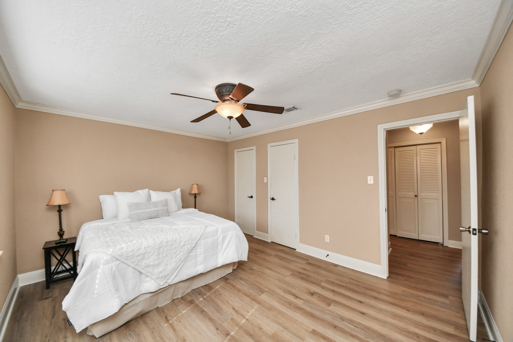 Retreat to this generously sized upper-level primary bedroom, where comfort meets understated style.