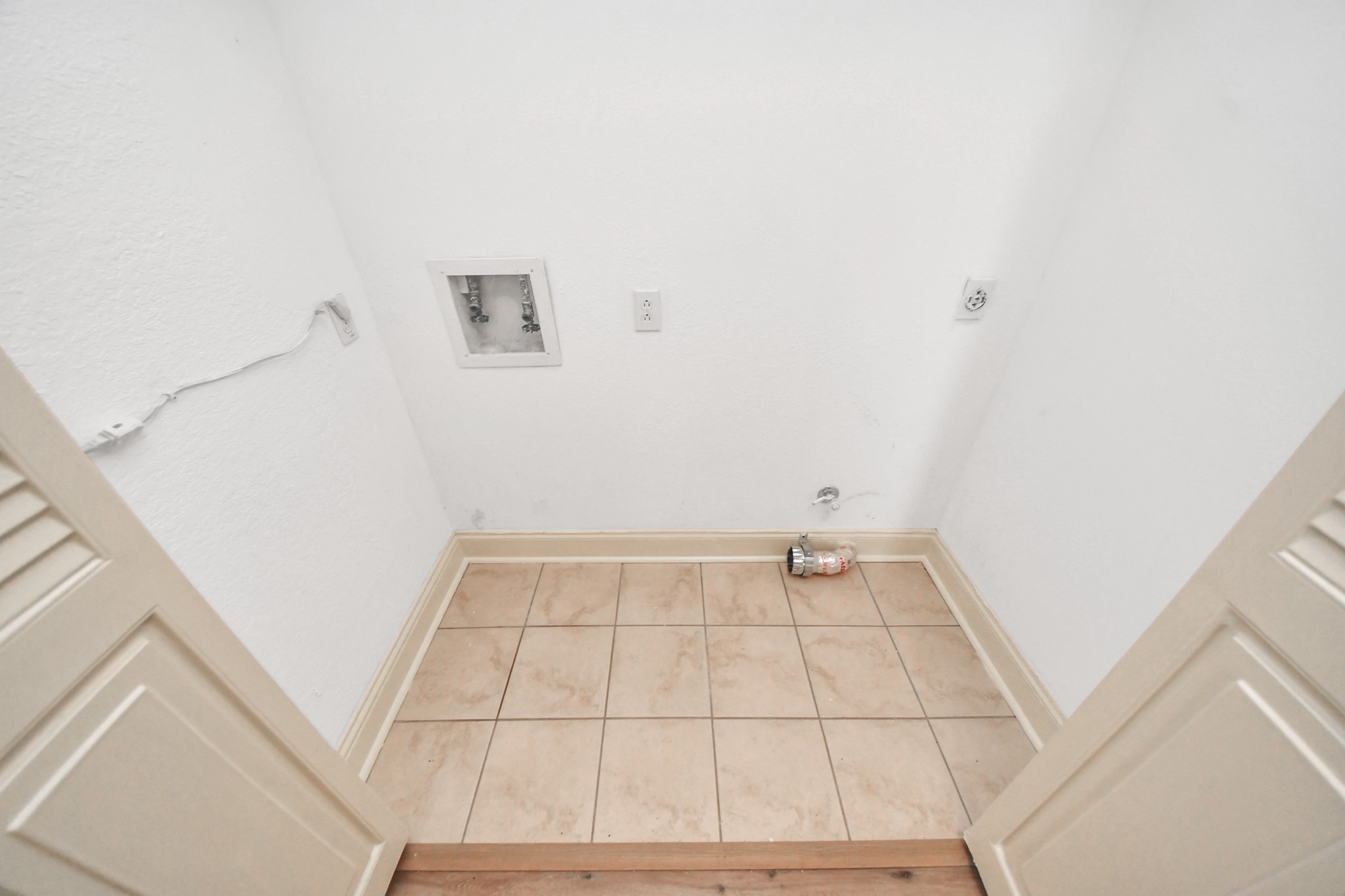 This upstairs laundry closet is thoughtfully located in the hallway near the primary bedroom and primary bathroom, making everyday laundry tasks easier and more convenient.
