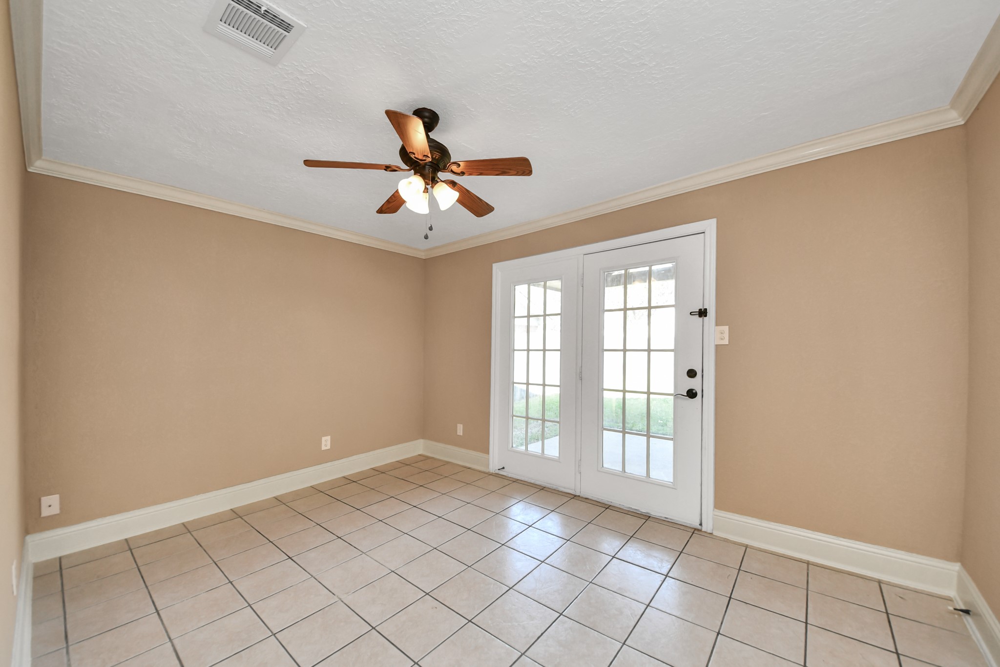 Imagine having a room where you can work, entertain, or simply unwind after a long day! This versatile first-level secondary bedroom features beautiful French doors that open directly to the backyard and covered patio, creating a seamless connection between indoor comfort and outdoor relaxation.